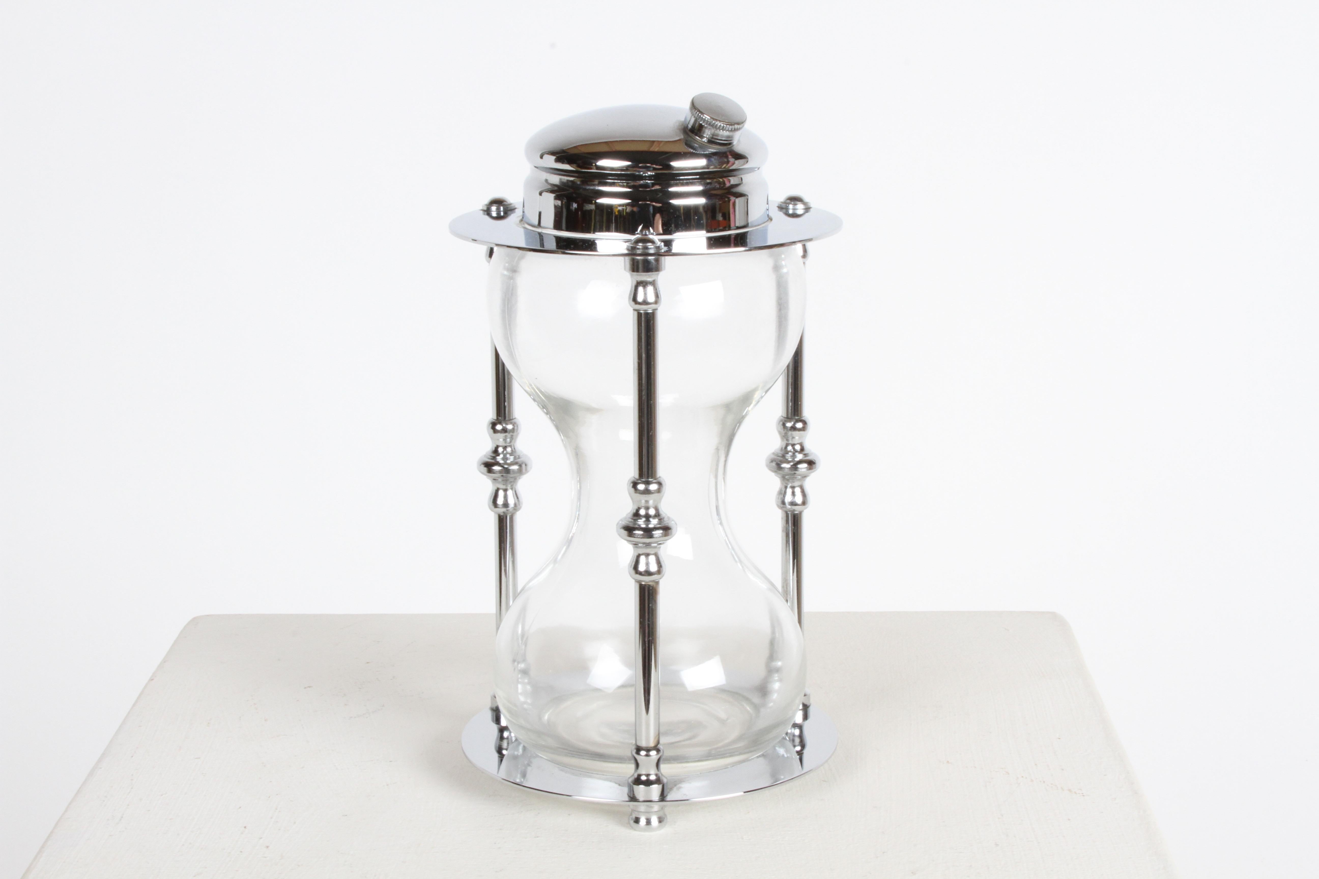 Unique and rare novelty Art Deco chrome & glass hourglass shaker by the Maxwell-Phillips Company, circa 1930s. All original and complete, but has a minor split in cap, see image, otherwise only few minor scuffs to the chrome base underside. Stamped