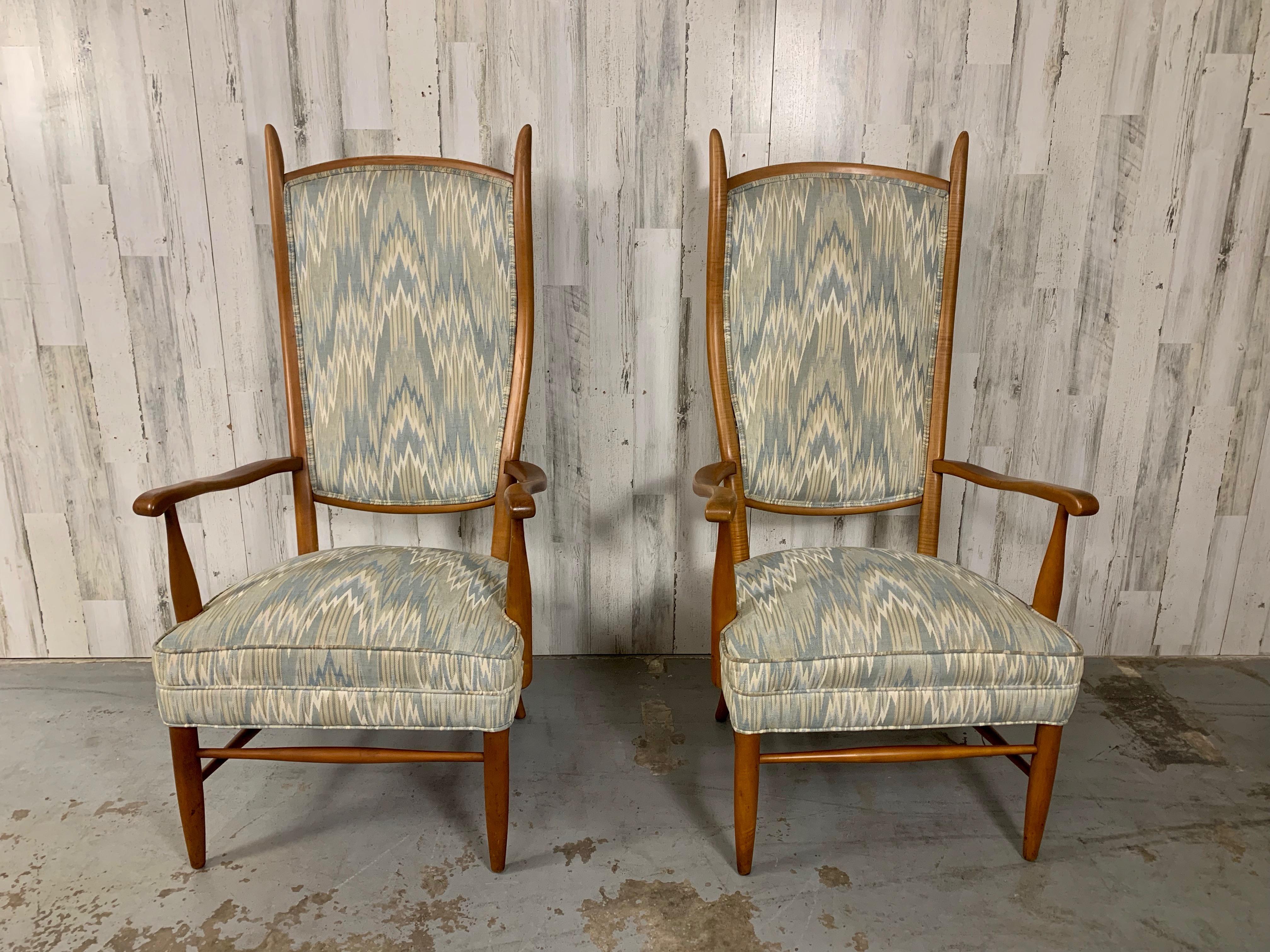 Great comfort can be found in these sculptural high back chairs with curved lines of the back and arm rest. Original flame stitch upholstery that adds movement to it's presence with maple hardwood frame helps this set as a rock of stability.