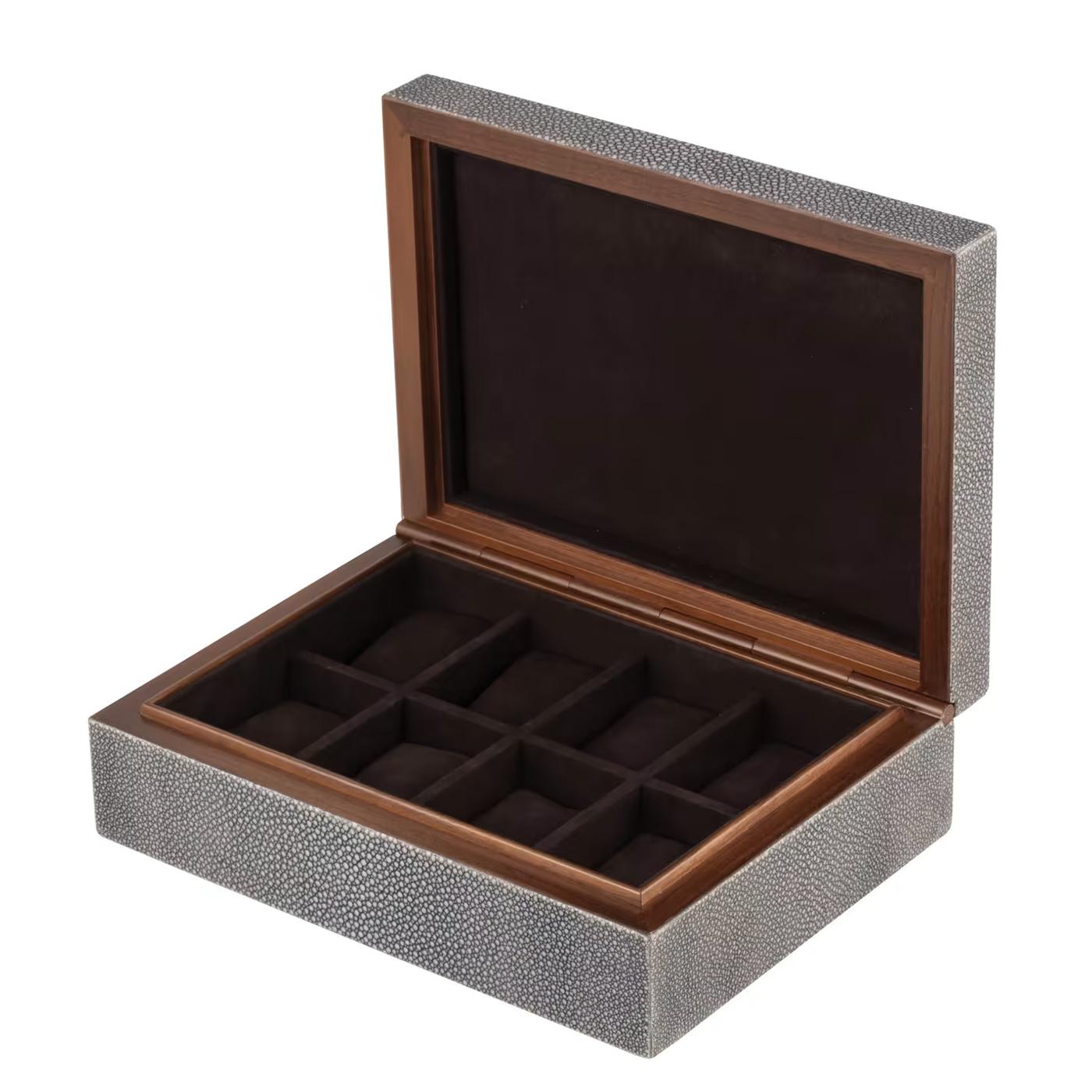 Watch Box Maxwell Shagreen with structure in solid
walnut wood covered with natural shagreen grey skin.
Inside with 8 parts all covered with dark brown velvet.