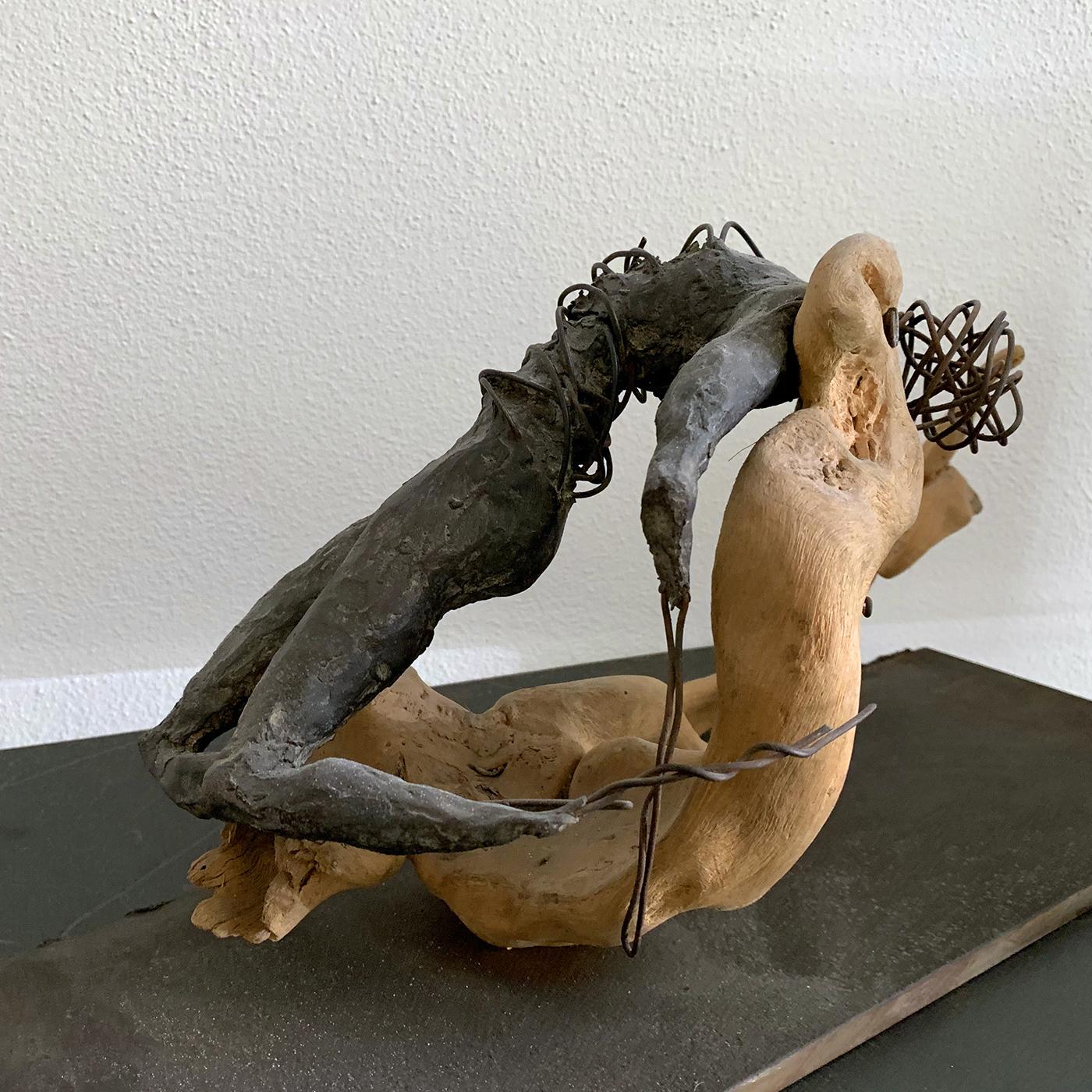 A magnificent piece of refined allure, this sculpture merges feelings of solitude, freedom, and peace in a female resting body. Exquisitely crafted of bronze using the ancient method of lost wax, the lying figure is wrapped up with copper wire
