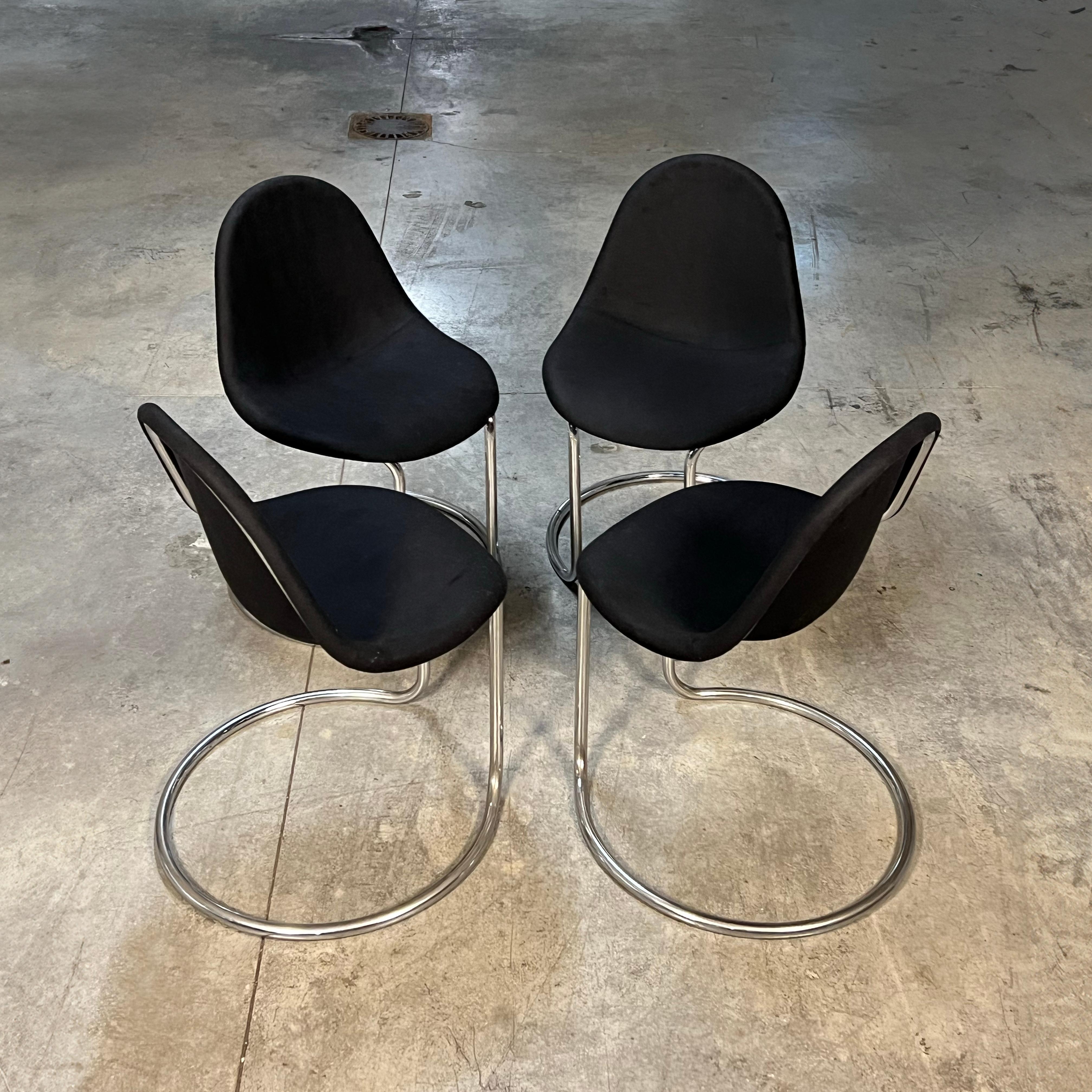 A collection of four Maya chairs crafted by Giotto Stoppino for Bernini during the 1970s, these chairs have undergone recent reupholstering with a luscious, dense black fabric.

The organic form of the chair's shell is affixed to a cantilevered