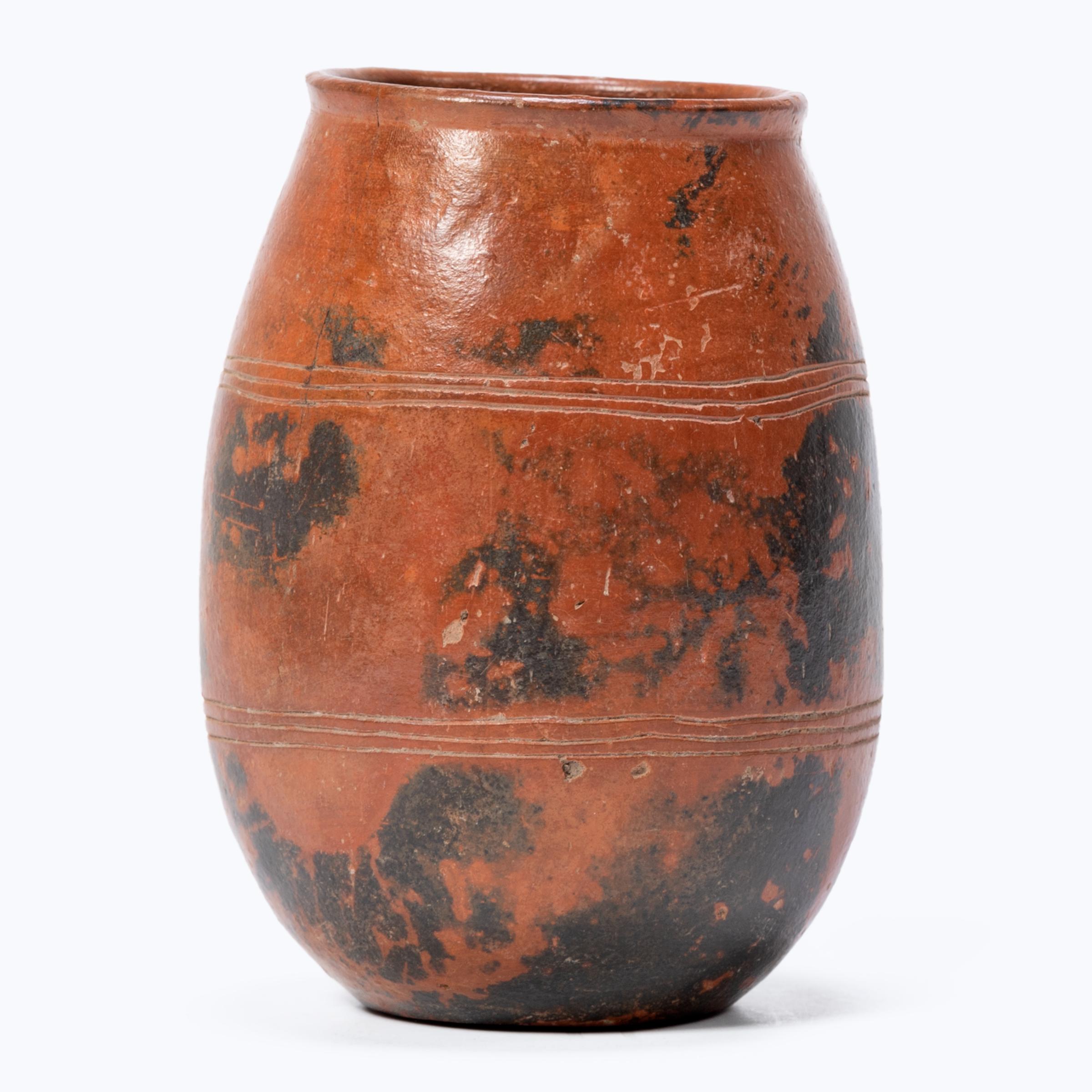This elegant redware vessel is an exquisite example of Maya ceramics. Finely sculpted with thin walls and a balanced form, In a process known as 