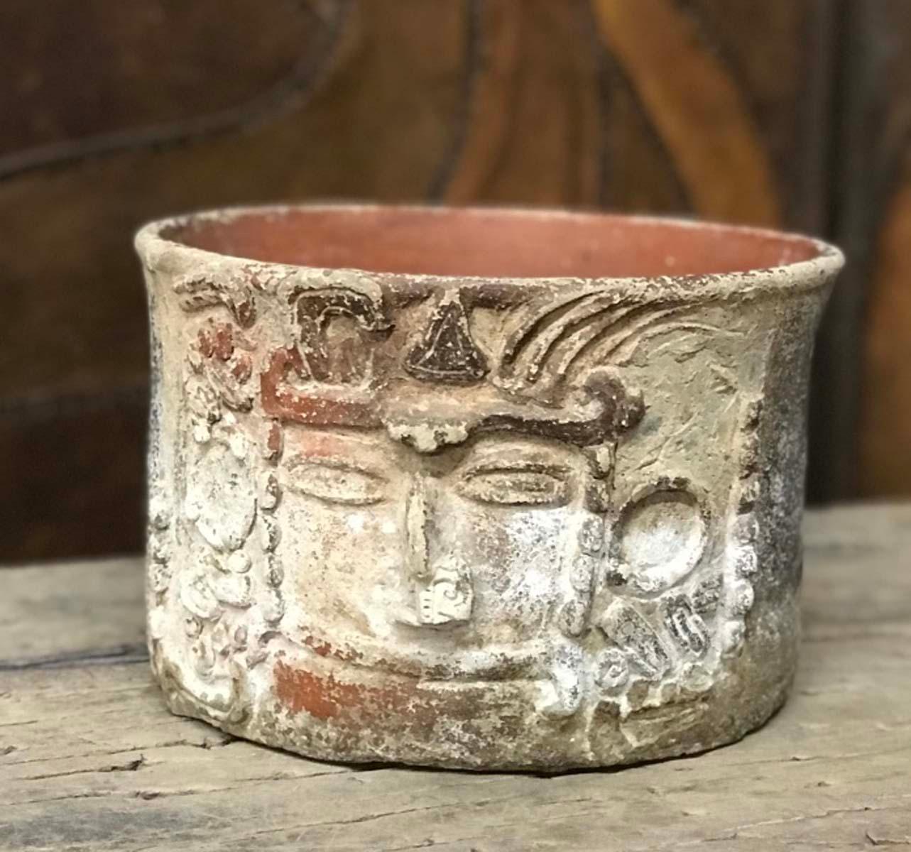 Very old, indigenous Mayan terracotta vessel depicting a face in relief.
Much of the paint has been lost but there is gesso and traces of figurative drawings on the back, with some very old red and black paint. Beautiful ritual vessel. Ancient but
