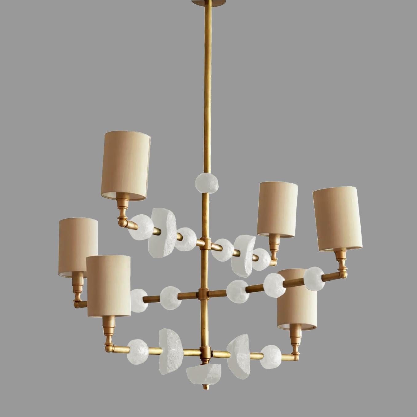 This contemporary three-tier chandelier by Margit Wittig features sculptural components with organic and subtle textures, all cast and treated with multiple layers of patina and in her London studio. The contrast of white waxed bio-resin and