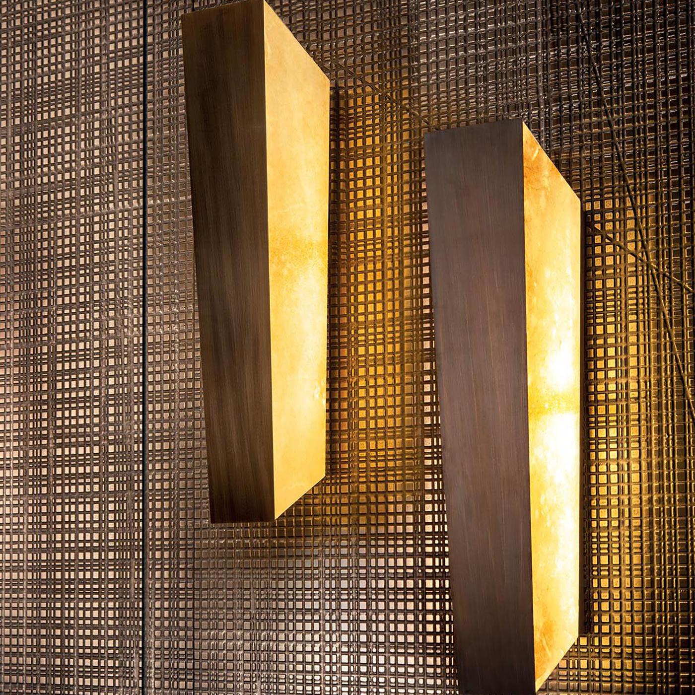 This striking LED wall lamp is inspired by the iconic Mayfair chandelier, and features the same parchment and burnished brass crafting, along with the characteristic geometric shape. Generous in size, yet elegant in substance and form, Mayfair Wall