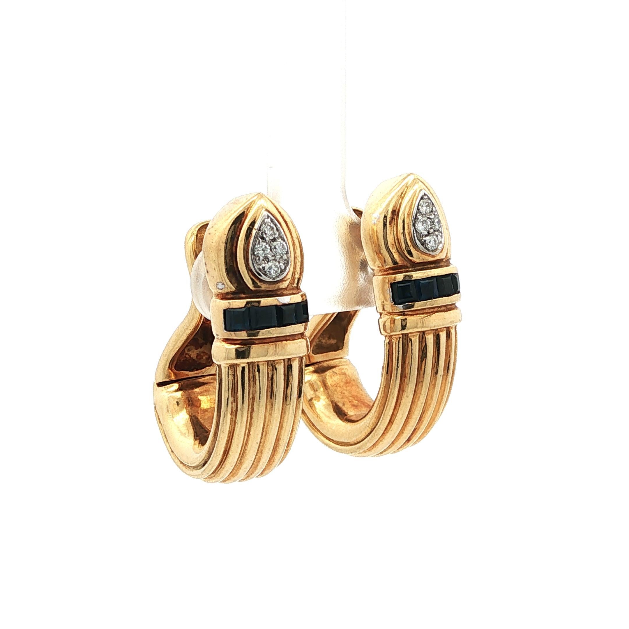 A stunning example of timeless elegance, these vintage MAYORS Door Knockers are masterfully crafted in 18K yellow gold and set with a refined combination of natural sapphires and brilliant white diamonds. Measuring 1.25 inches in length, they offer
