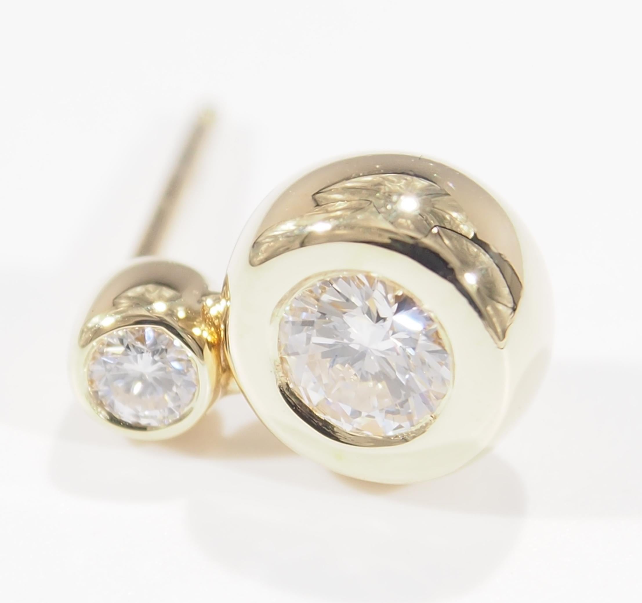 These are a classic pair of 14K Yellow Gold Diamond Drop Earrings. With (4) Round Brilliant Cut Diamonds, approximately 0.64ctw, G-H in Color, VS in Clarity that are bezel set and easily worn any day. They are Hallmarked 