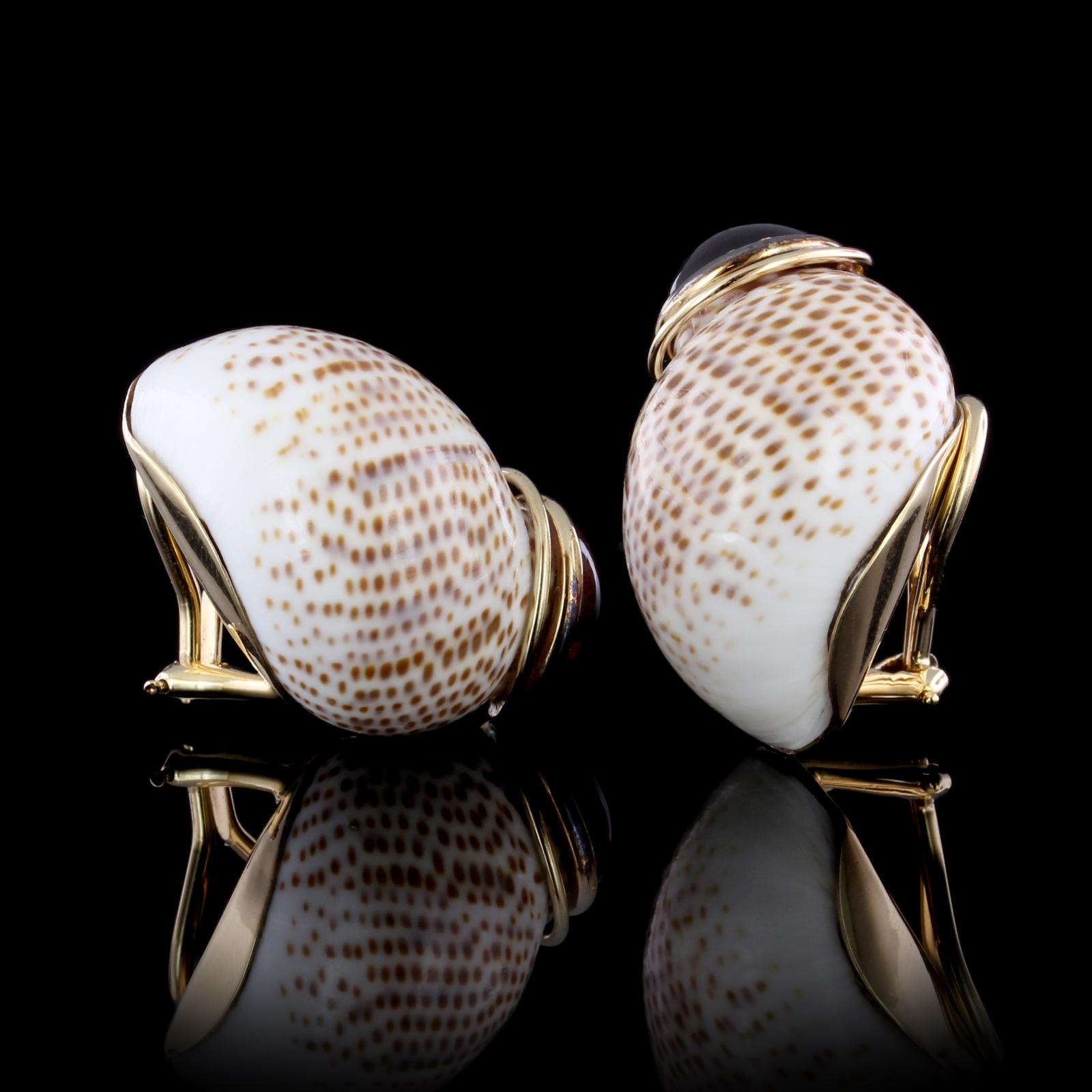 MAZ 14K Yellow Gold Seashell and Garnet Earrings. The earrings are designed
with natural seashells bezel set with two cabochon garnets each measuring
10.00mm., length 1