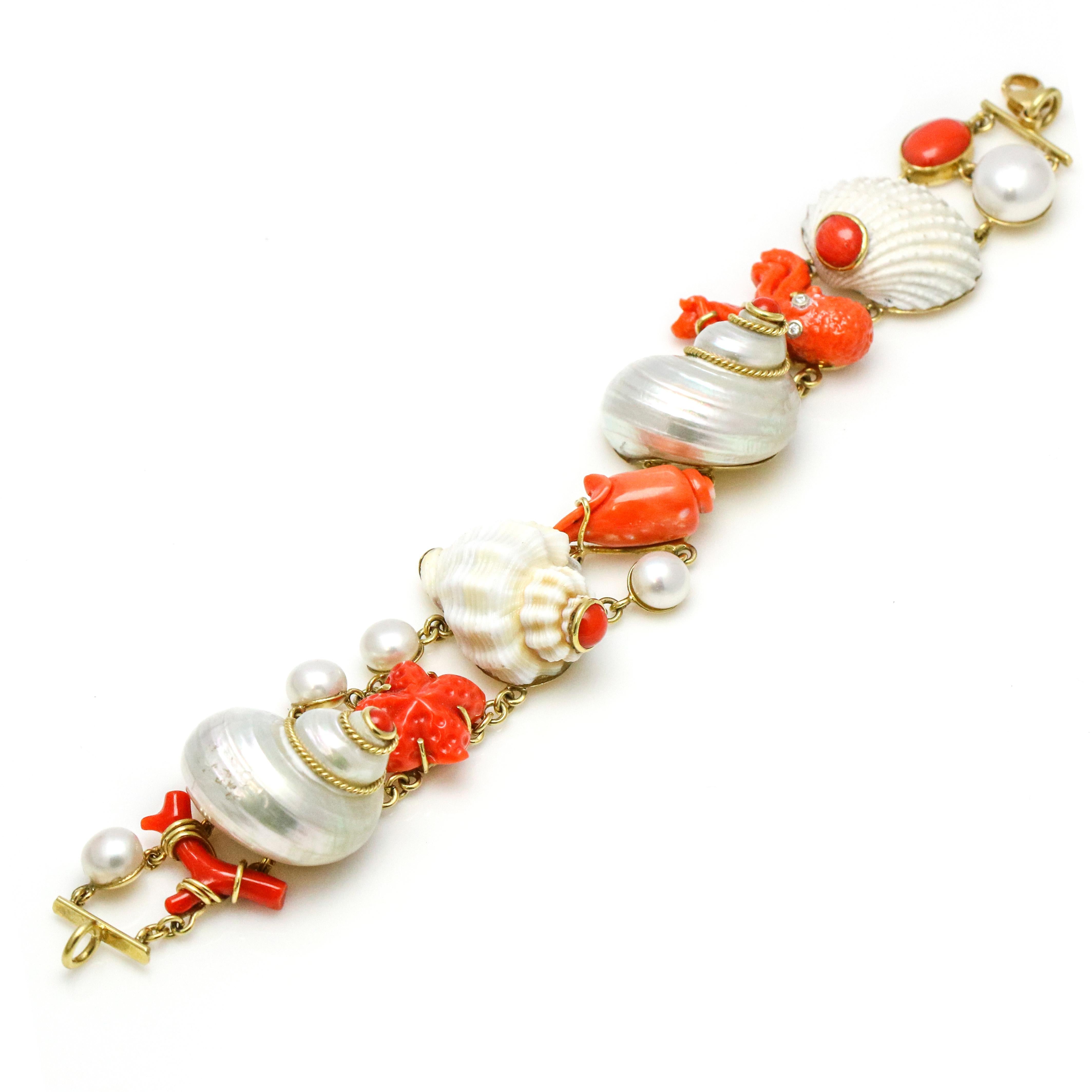 Mazza Company shell, coral, diamond and pearl sea life charm bracelet in 18k yellow gold from the Grotto collection. Size, medium. Lobster clasp.

Width, 25mm
Height, 21mm
Weight, 50.5 grams
Carat Weight, .05 carat
