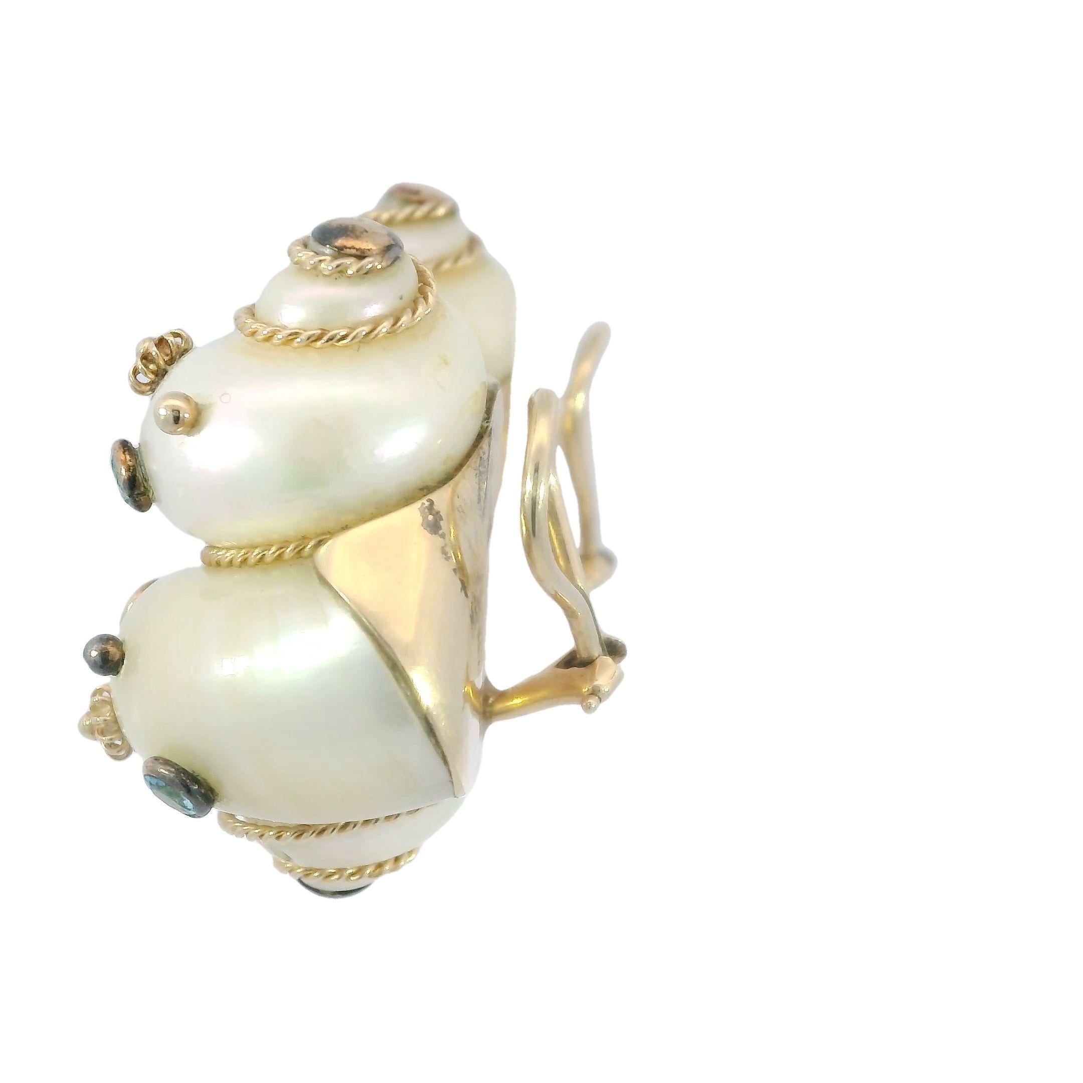 Maz Aquamarine Turbo Shell Clip On Earrings in 14K Gold 

The Maz Aquamarine Turbo Shell Earrings bring a playful and beachy vibe to any look, blending elegance with a sense of fun. Crafted in 14k yellow gold, these earrings are inspired by the