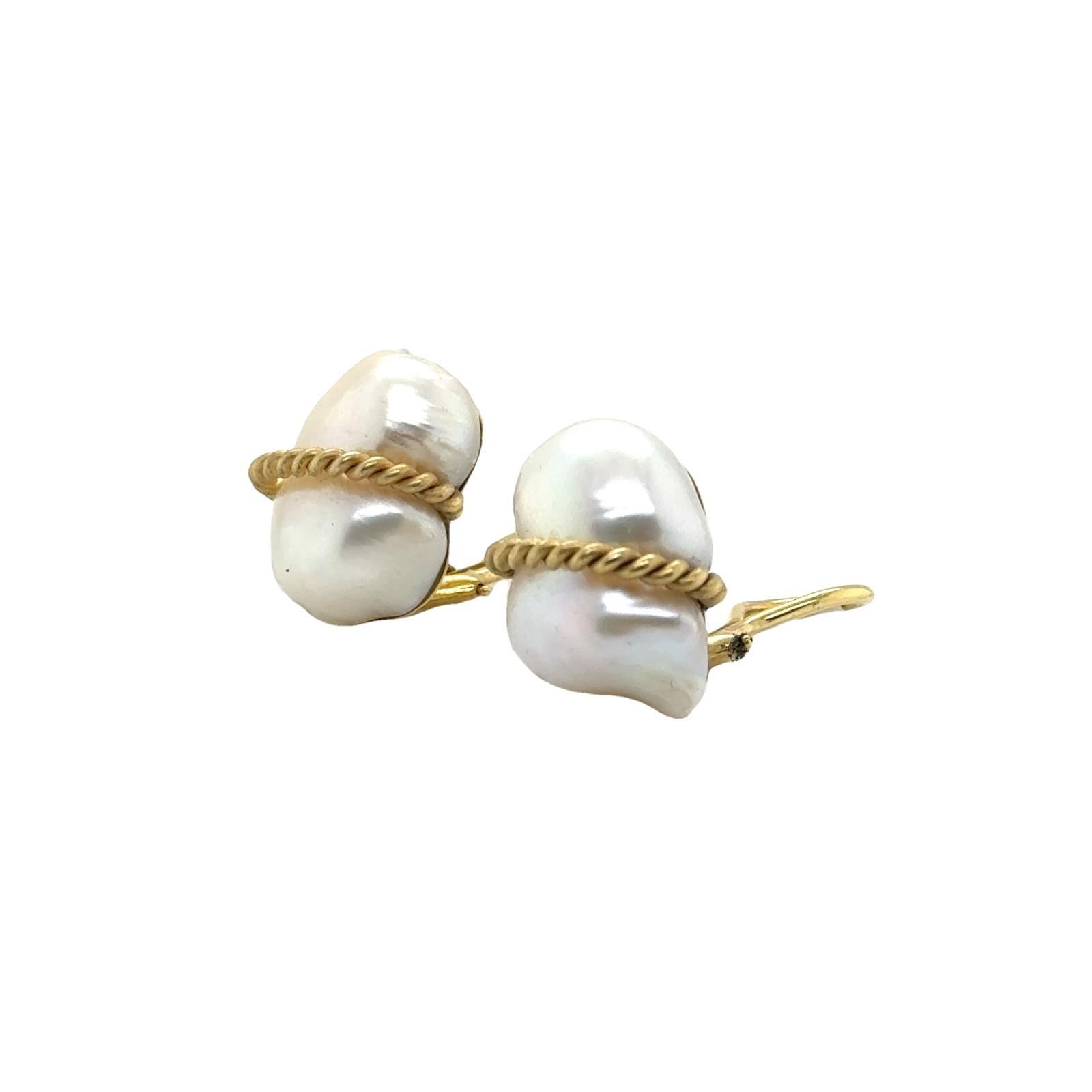 The Baroque Pearl Earrings by designer Maz are a captivating blend of natural beauty and refined craftsmanship. Featuring lustrous baroque pearls, each uniquely shaped, these earrings are set in elegant 14 karat yellow gold. The ear-clip design