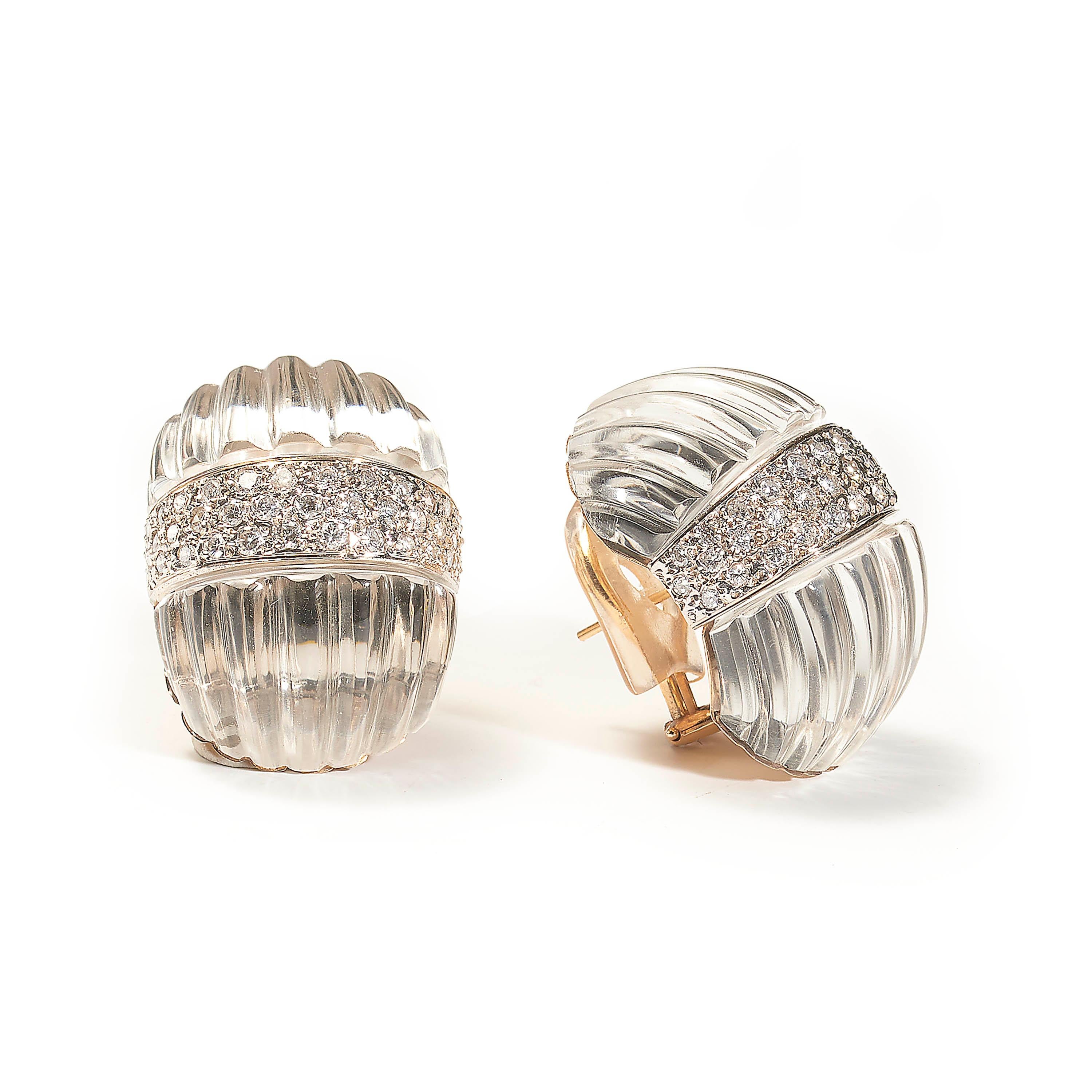 A pair of modern rock crystal and diamond earrings by Maz, comprised of two fluted sections of rock crystal, flanking a central band of pavé set brilliant-cut diamonds, weighing an estimated total of 2.25 carats, with posts and hinged clip fittings,