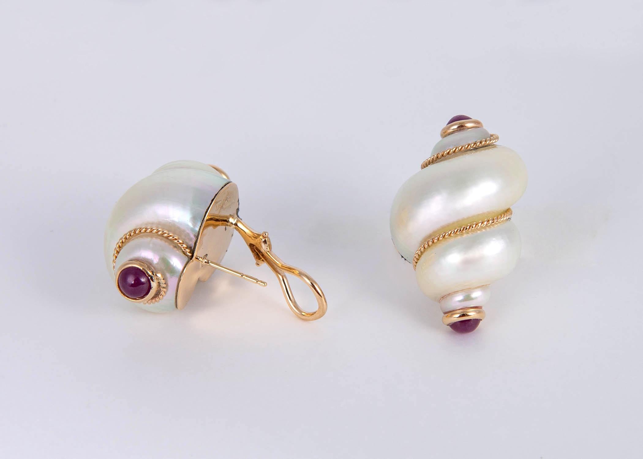 Maz is famous for there beautiful natural shell earrings. This pair features crisp white natural turbo shells accented with cabochon rubies. 1 1/4 inches in size. Playful and Chic !!!