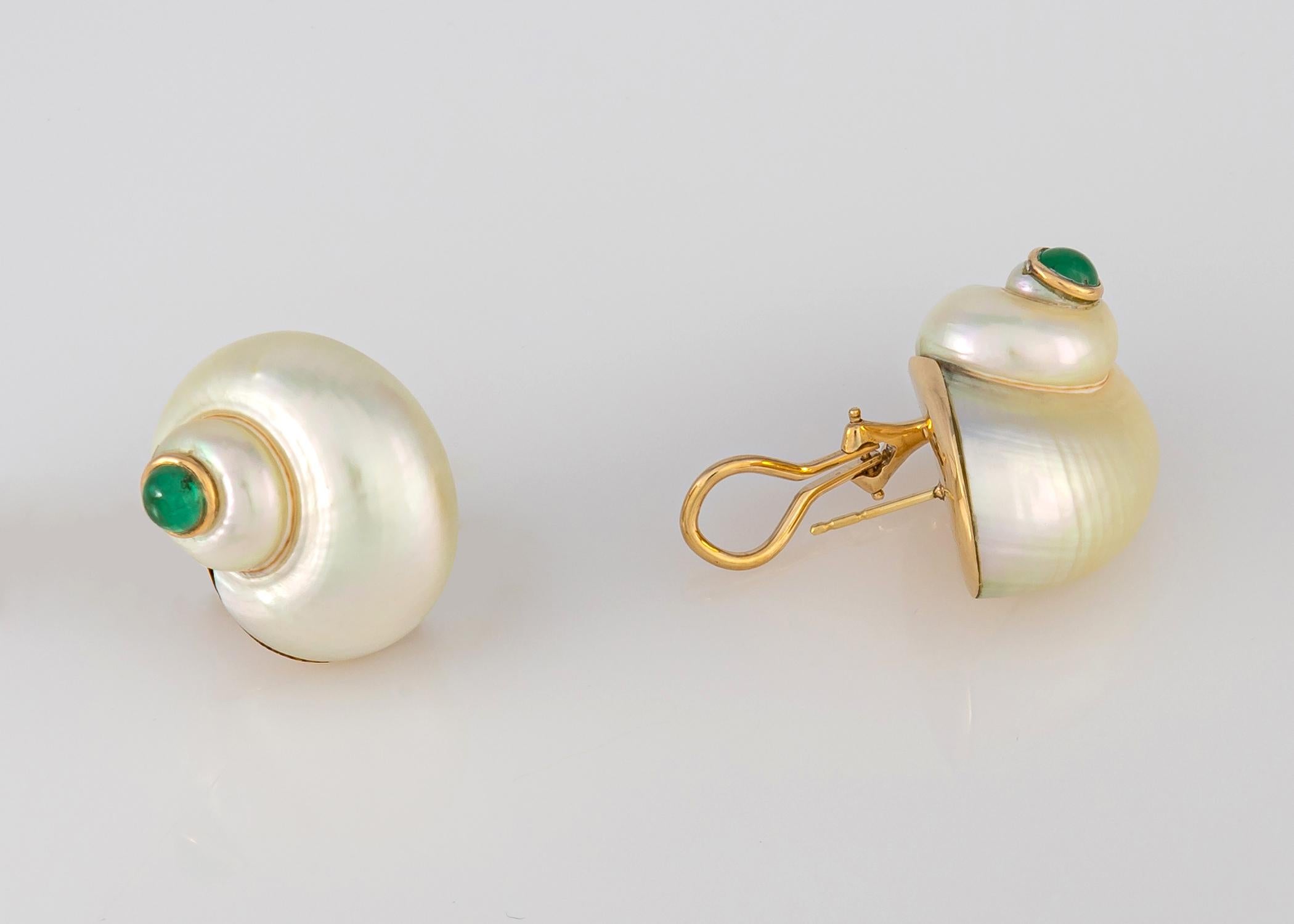 Simply classic. Glowing white natural shells are finished with cabochon emeralds and yellow gold bezels. Easy to wear and a wonderful flattering shape. 1 inch in size.