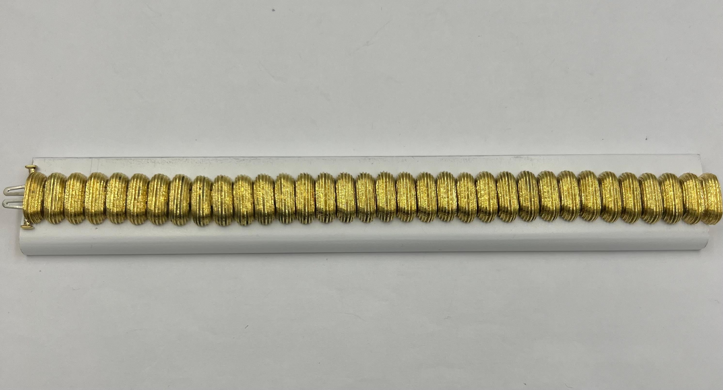 MAZ yellow gold ribbed link bracelet, Circa 1990s.

  This Maz Yellow Gold Ribbed Link Bracelet is a stunning piece of jewelry with its intricate ribbed design and luxurious yellow gold finish, this bracelet exudes elegance and sophistication. Not
