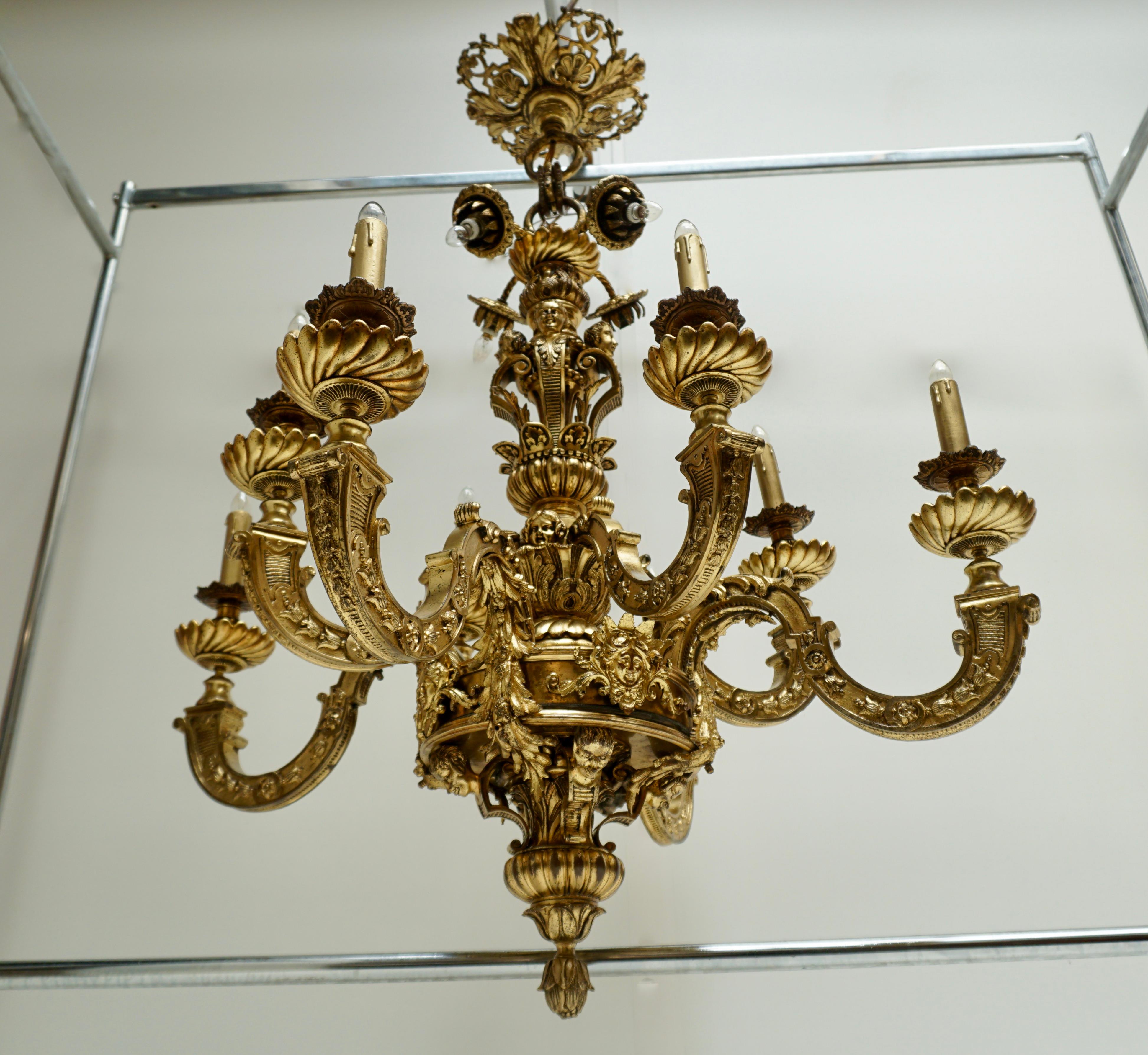 A spectacular and important bronze chandelier, a so called “Lustre Mazarin”, of superb quality, with 8 arms and above these, 4 lights and in the middle of the balluster 4 heads on scrolls , and underneath 4 angel-heads. The chandelier dates from the