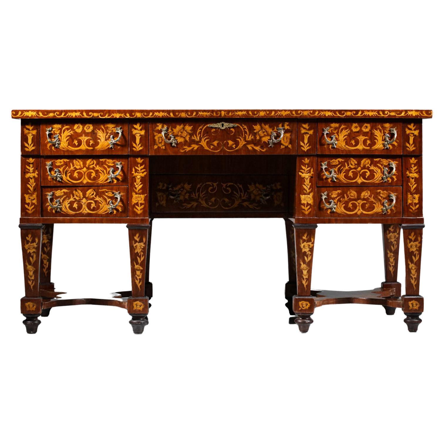 Italian desk in the Mazarin style of the XXI century. Solid wood and veneer structure, gilded metal handles and brown leatherette desk pad. The desk is entirely covered with marquetry with very decorative floral motifs and has a total of 7 drawers.