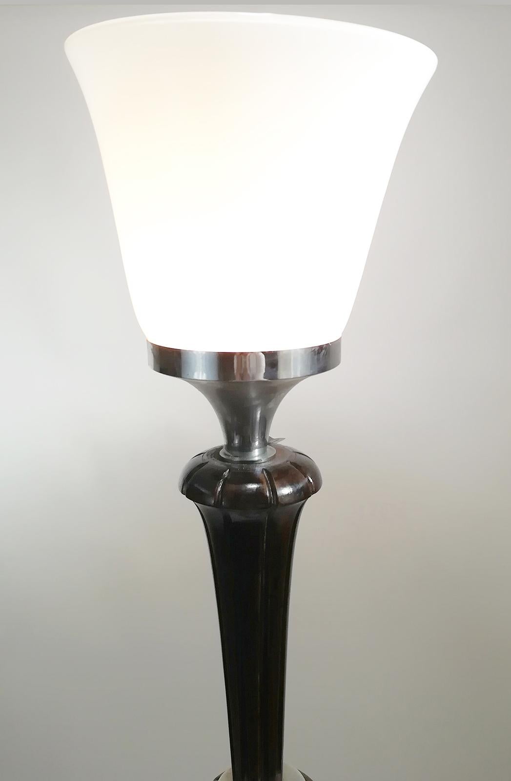 French origin Art Deco floor lamp. Consist of a dark brown wooden shaft, a circular base with opaline Mazda shade.
A dimmer is connected to the light fixture to lower the brightness of light.
It Accommodate one candelabra bulb: 150 Watts
Can be