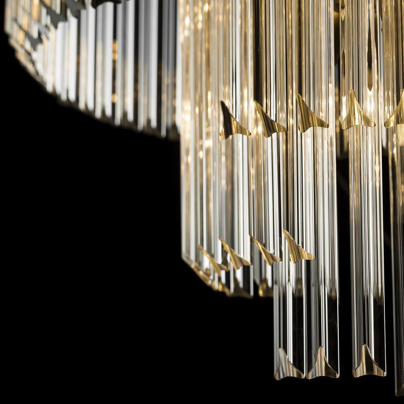 A spiral-shaped maze of fascinating lights, this stupendous chandelier will make for a stately addition to a modern-style interior. It features a round profile, comprised of a series of transparent glass trihedrons, interacting in an extraordinary