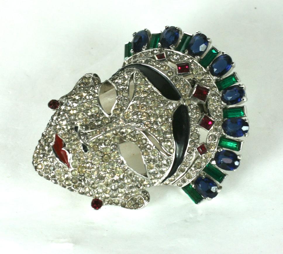 Mazer Art Deco Asian Princess Clip from the 1930's. Beautiful quality work with faux sapphire, emerald and ruby stones with black enamel highlights set in high rhodium metal. 
This clip is unsigned, although it is well known as a Mazer design and