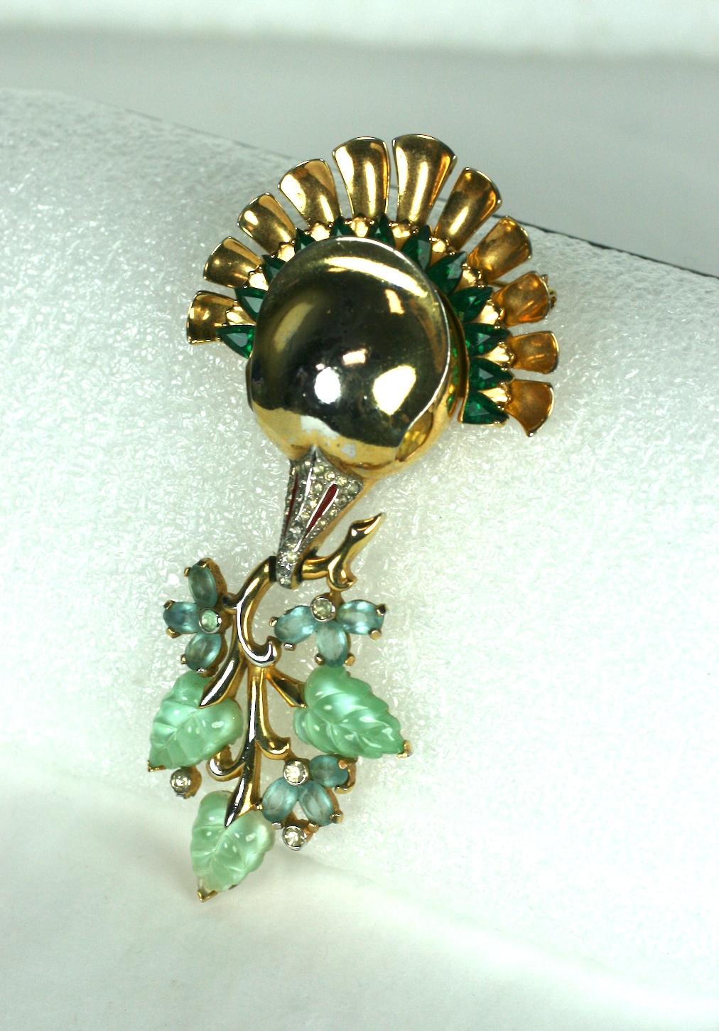 Amazing and Rare Mazer Fruit Salad Bird Brooch from the 1930's. A large gilt bird's head with pave beak is set with faux emerald triangular stones along the collar. Clasped in the bird's mouth is an articulated vine of green moonstone leaves and