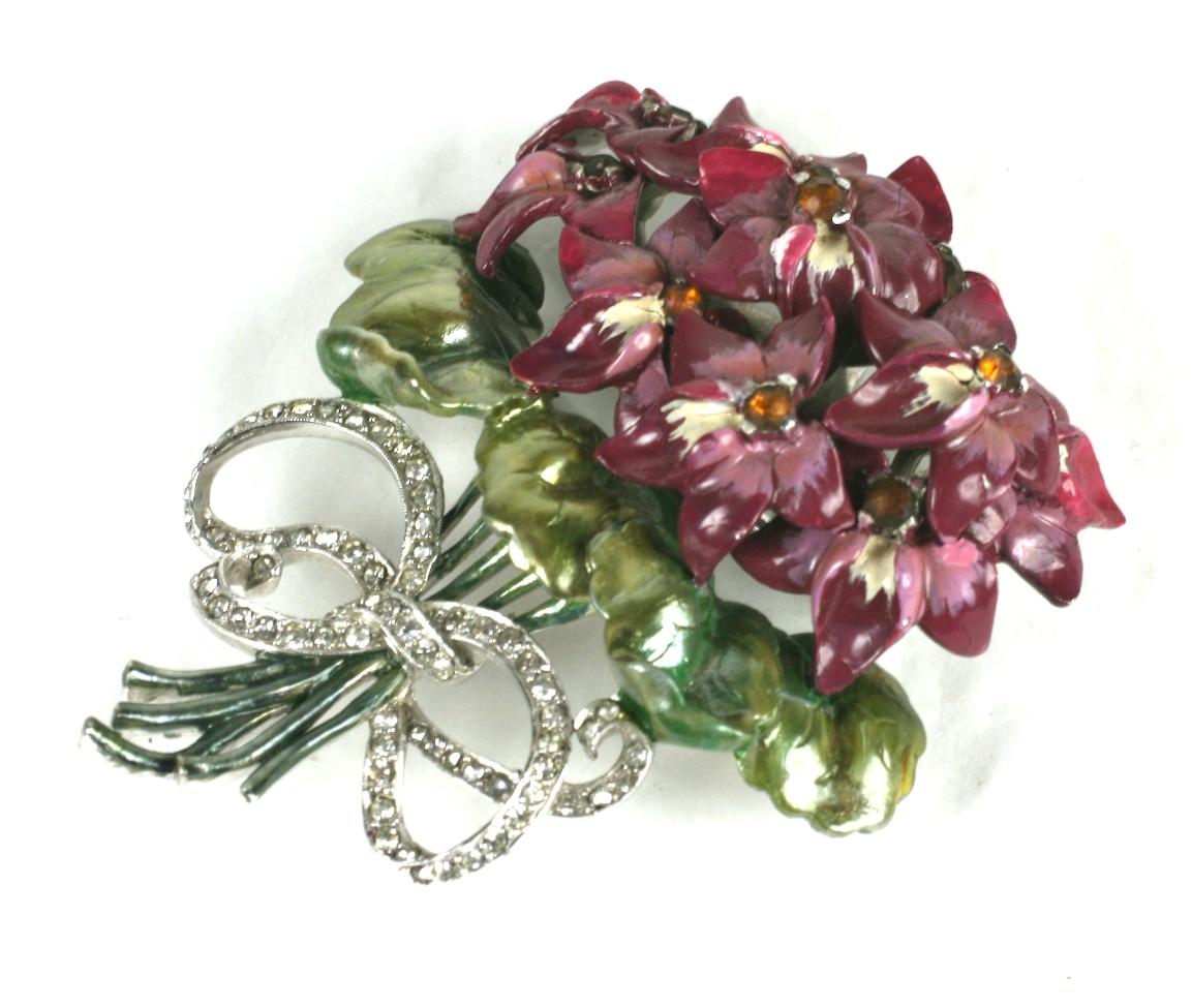 Large and wonderful Mazer violet bouquet brooch of pearlescent cold enamel. The finely detailed cold enamel is painted in shades of purple violets with ombre green leaves set with amber crystal rhinestones. The bouquet is tied with a crystal pave