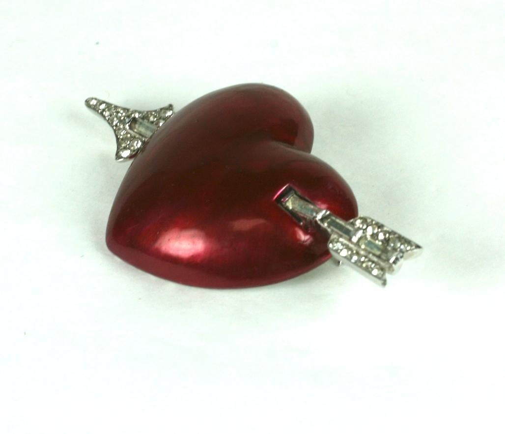 Mazer red pearlized cold enamel heart brooch of rhodium plate base metal. The heart pierced  with an arrow or crystal round rhinestone and baguettes. 1930's USA. 
Excellent Condition, Signed Mazer
