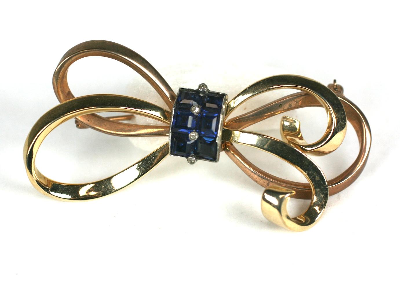 Mazer 2 toned (pink/gold) washed sterling silver Retro bow knot brooch. The bow loops held by calibre faux sapphire squares and crystal pastes,
Excellent Condition Signed Mazer, Sterling. 1940's USA.
Length 3