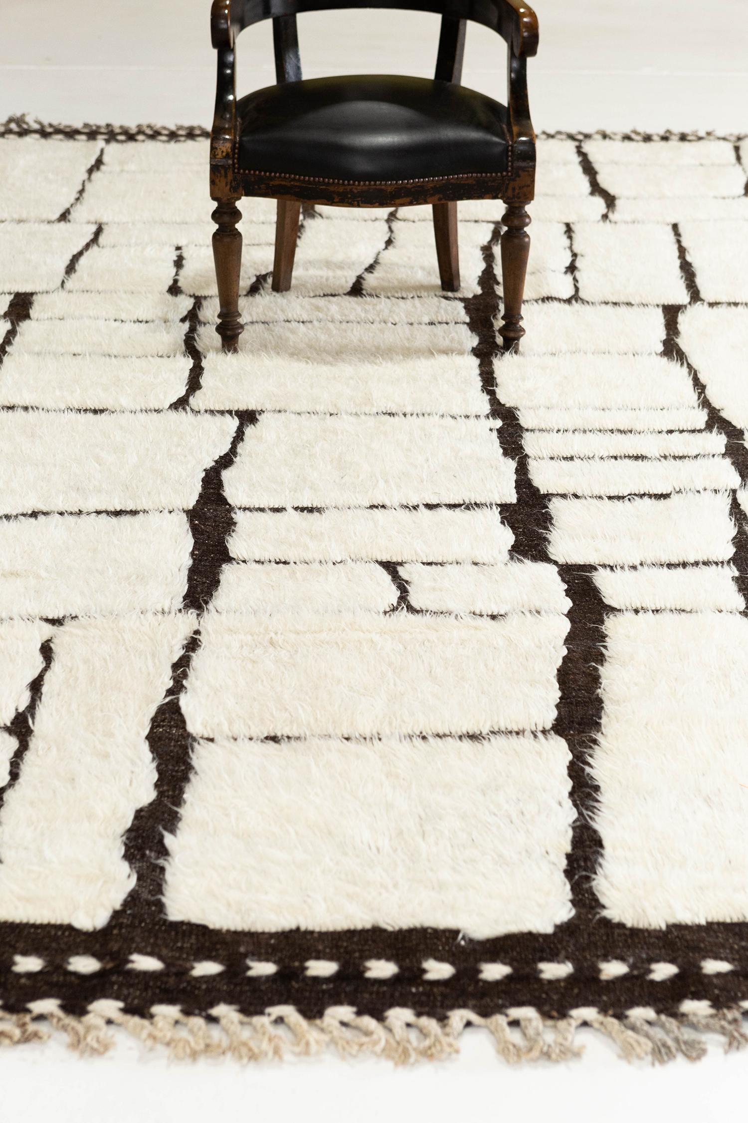 Maziere' is a handwoven wool piece with unique design elements that mirror roman masonry. This luxurious black pile weave and white shag make for the perfect contemporary. Maziere is designed in Los Angeles for the modern design world.