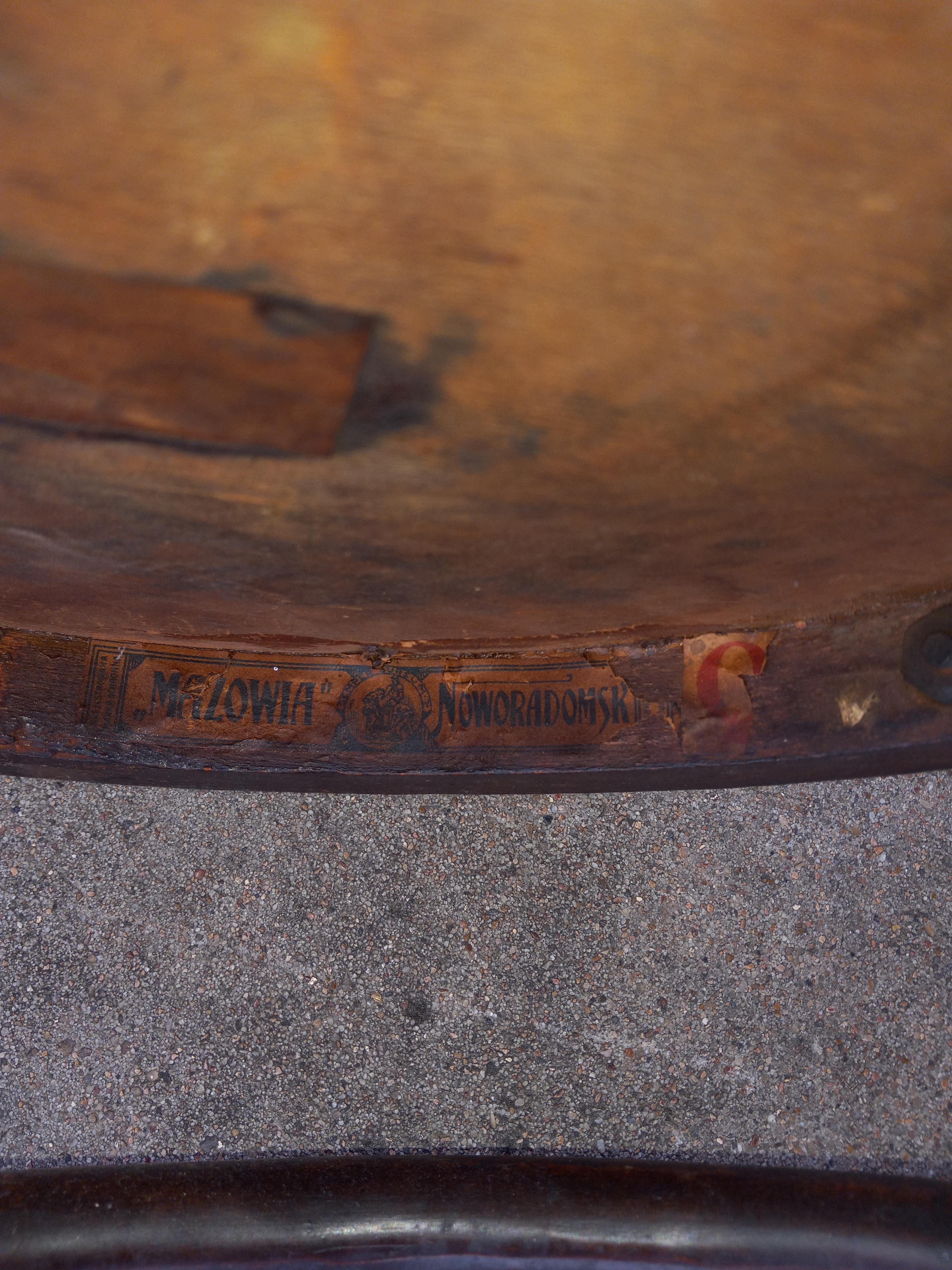 Grotto style bentwood chair marked with Mazowia as the maker. Chair features bentwood back with beautiful curved wood. Seat features a beautiful fleur-de-lis pattern or shell embossed into the wooden seat. Condition is consistent with age and wear.