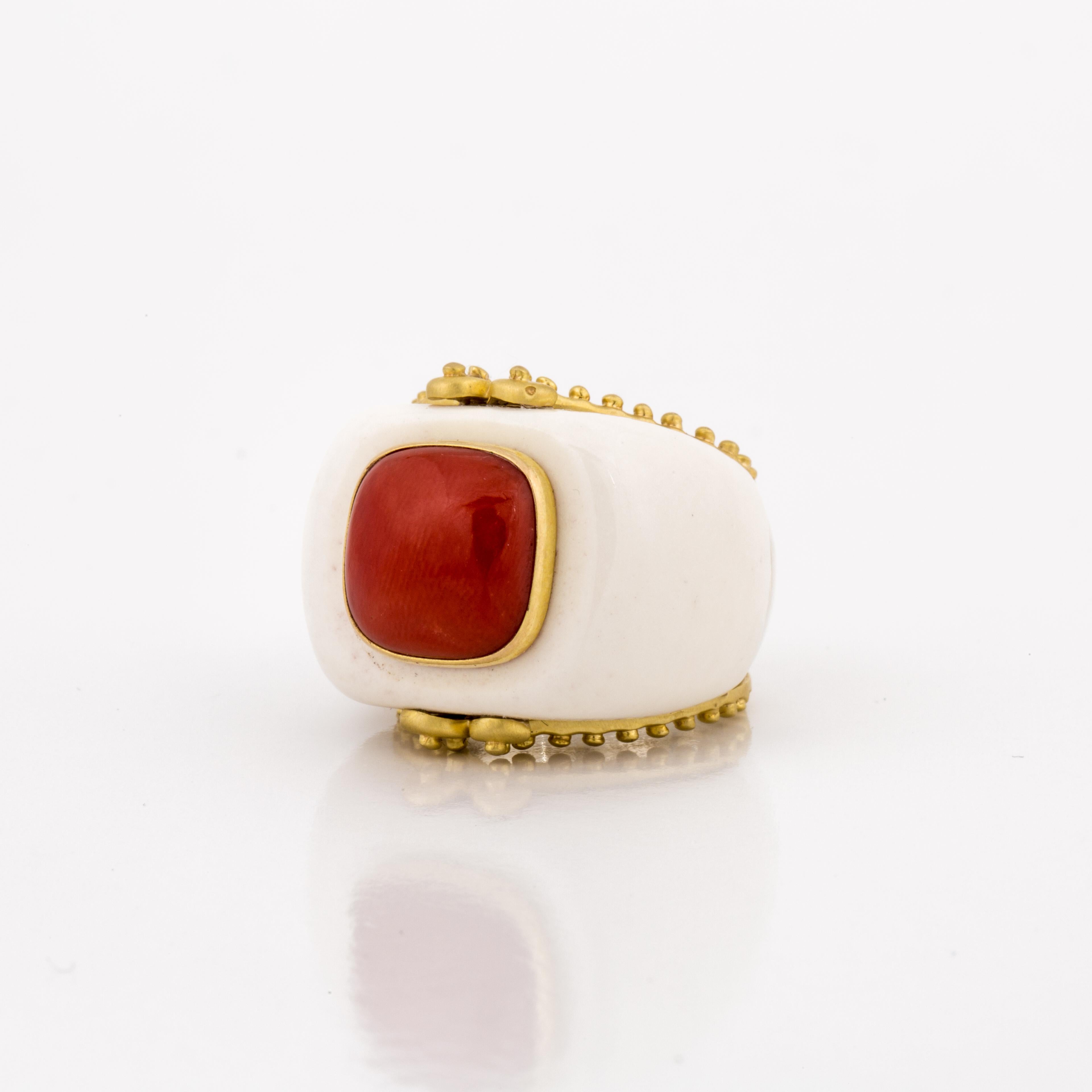 This modern ring by Mazza is composed of sterling silver, 14K yellow gold, white agate and a cushion cabochon coral in the center.  The ring is trimmed with brushed finish 14K yellow gold, and the shank and interior is sterling silver.  The