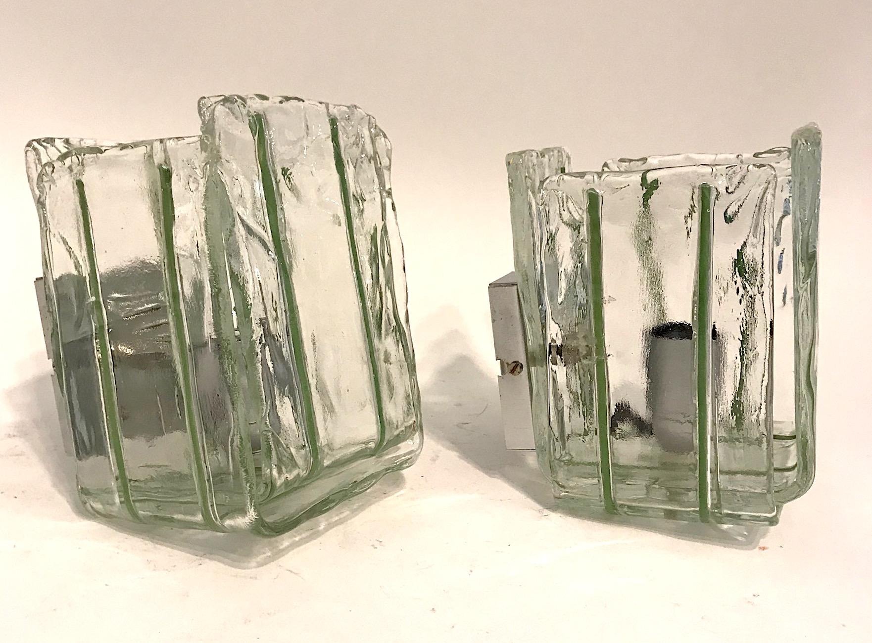 Simple yet, elegant is this pair of 1970s cube shape wall lights by Italian lighting company Mazzega. Each sconce is comprised of two pieces of hand formed U shape pieces of clear with grass green stripes. The surface and edges of the glass are