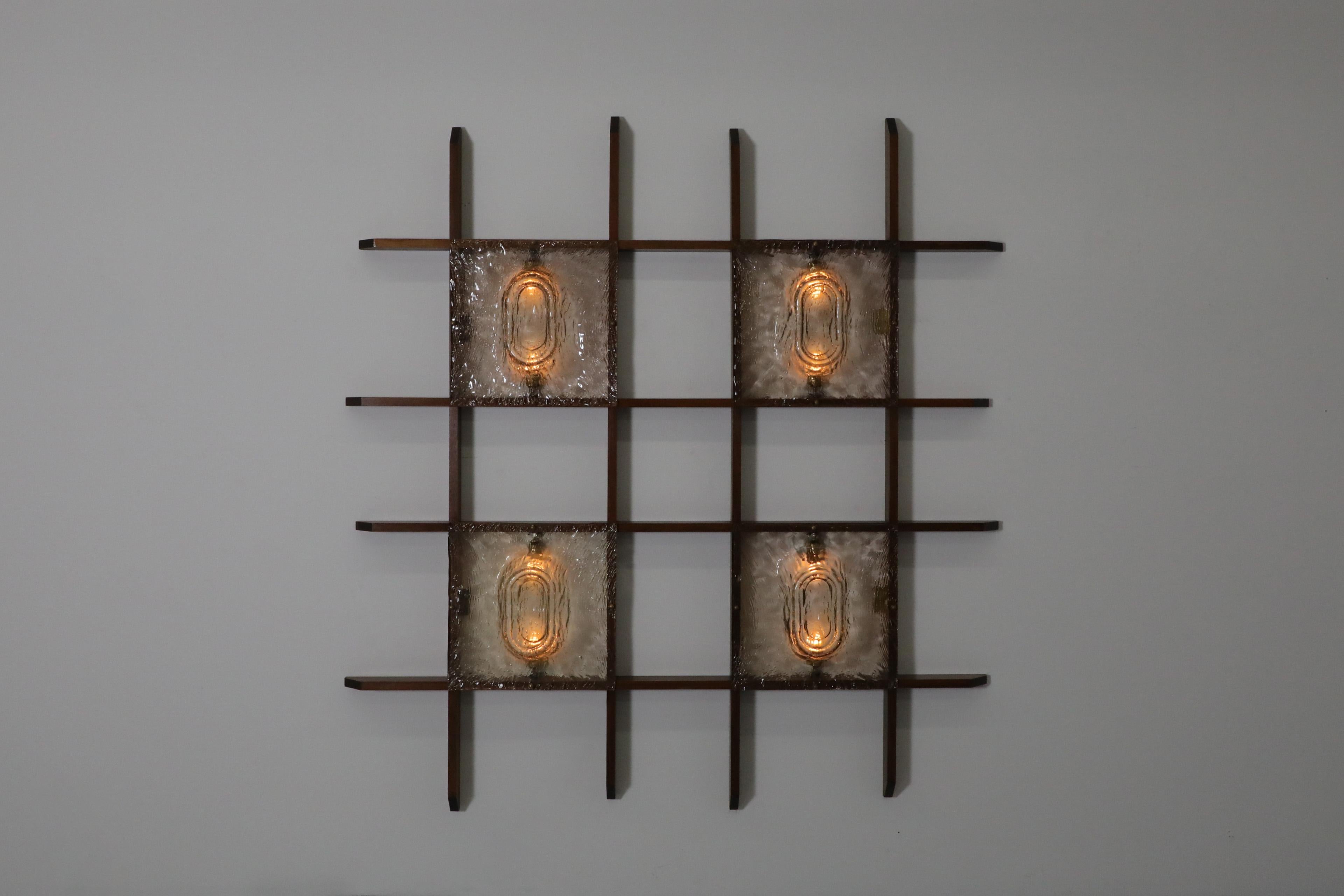 Mid-Century teak grid wall mount lights with four organic molded glass plate shades. A uniquely designed piece that mixes functionality and art to create a truly illuminating conversation starter. In original condition with some visible wear