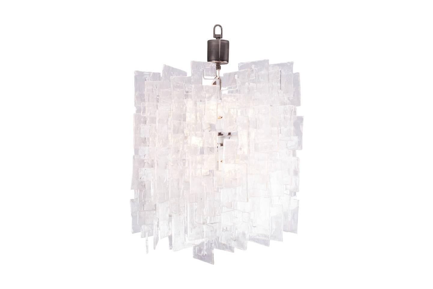 Impressive Mid-Century Modern chandelier
designed by Carlo Nason for Mazzega with interlocking opalescent glass pieces.
This is one of the biggest of its kind at with 12 lighting points inside compared to mostly six and a diameter of 65 cm and