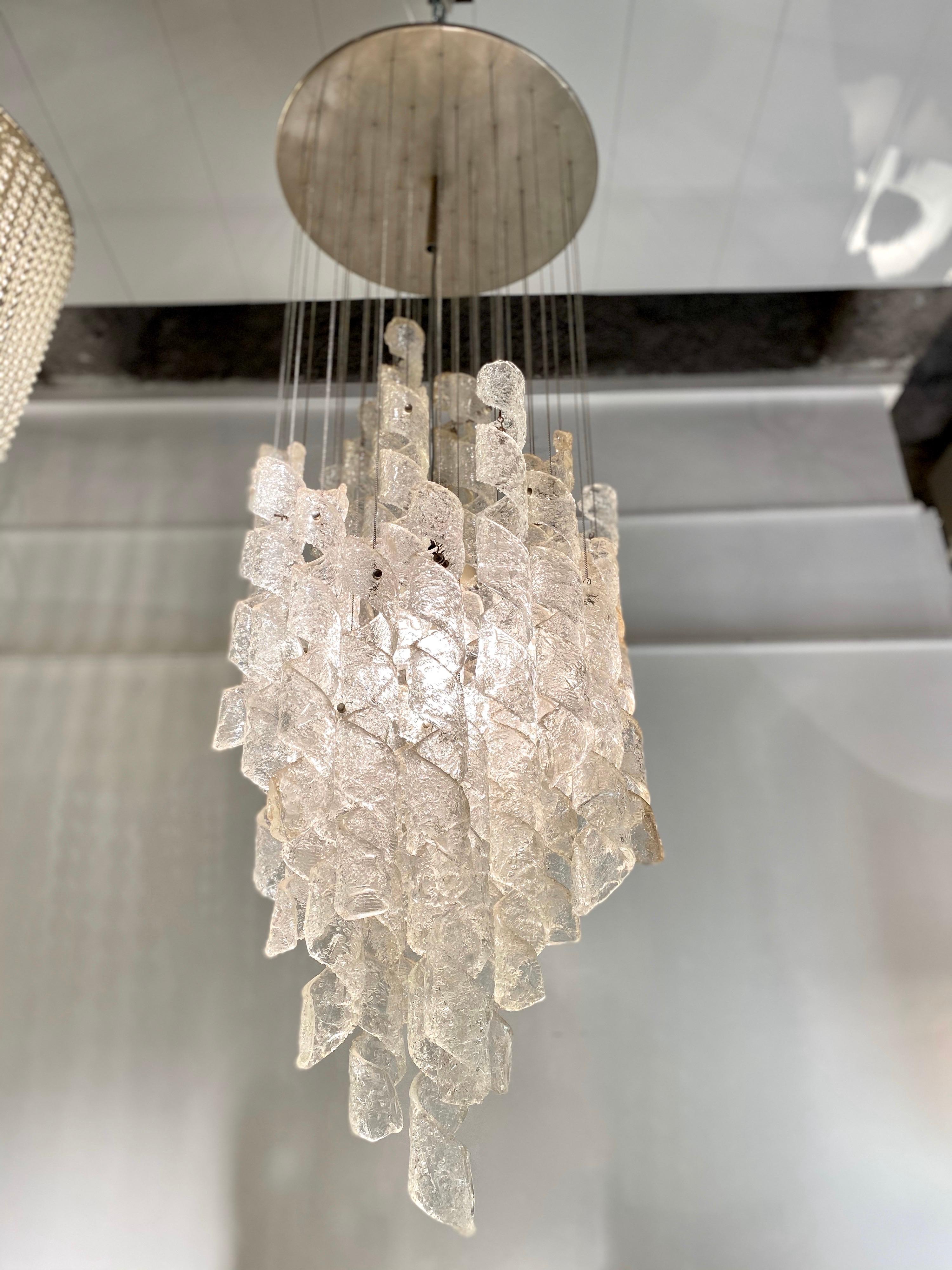 A rain of Murano glass spirals falling from the sky. This falling light has been made by Mazzega in Italy in 1970, each glass piece is attached to a delicate silver brass chain.
The Art of beauty and quality(handmade glass ), this chandelier is