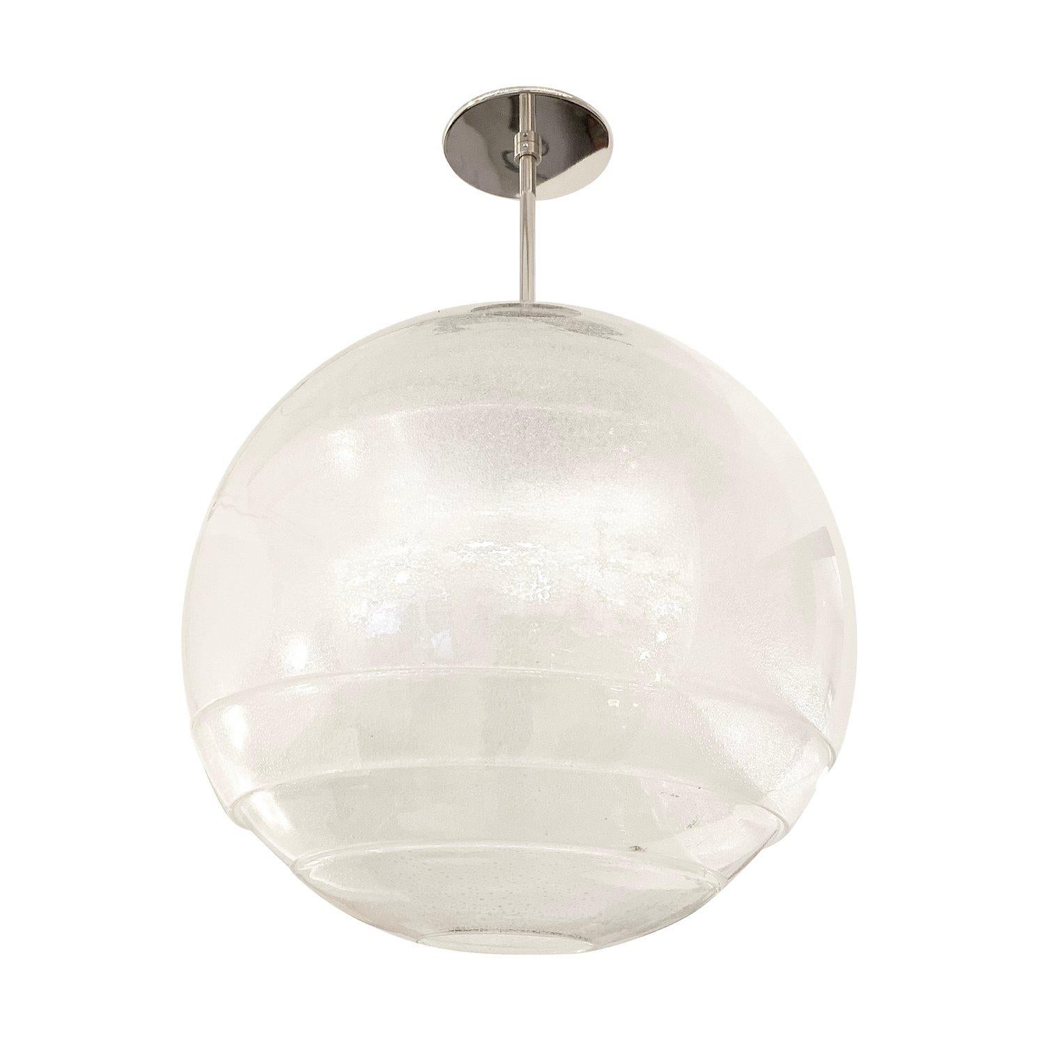 Spherical chandelier by Carlo Nason for Mazzega featuring several interlocking glasses which combined create a beautiful light effect. The handblown Murano glass is colorless with small infused bubbles. Holds one E26 socket. Nickel