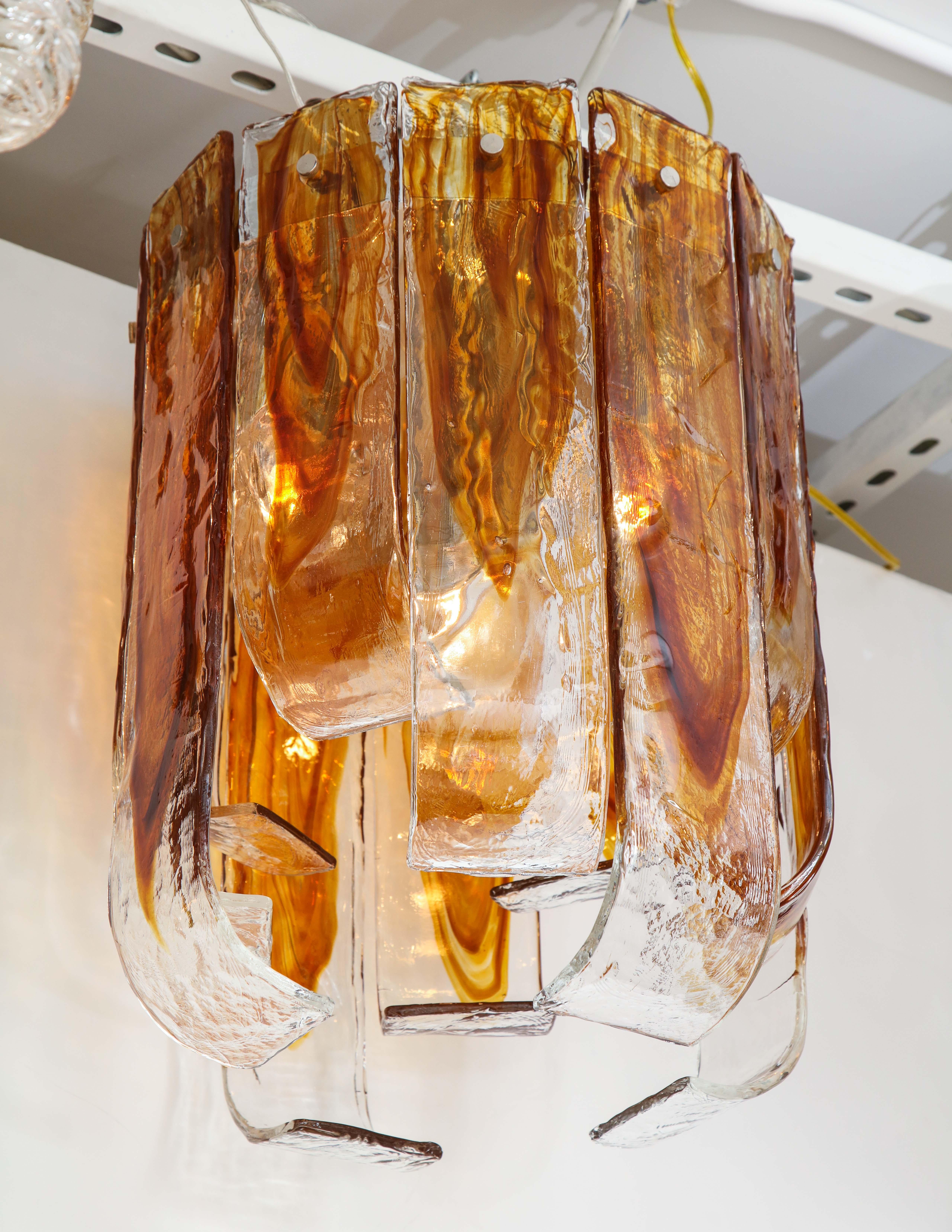 Midcentury flush mount featuring Murano glass curled elements in clear and amber tones. Glass can be configured with curves going in or flaring out. Rewired for use in the USA. 3 sockets.