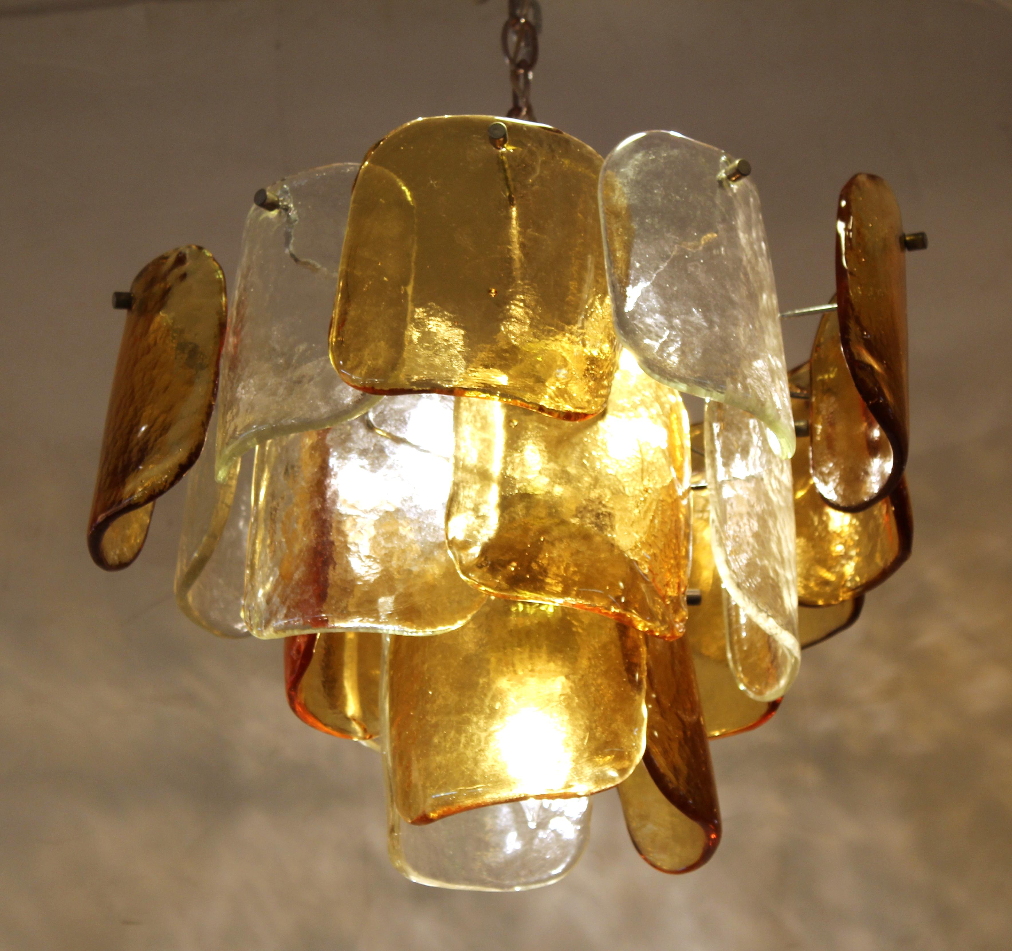 Mazzega Italian Mid-Century Modern glass chandelier with three tiers of glass elements in concentric circles. The piece was manufactured in Murano, Italy and is in great vintage condition.