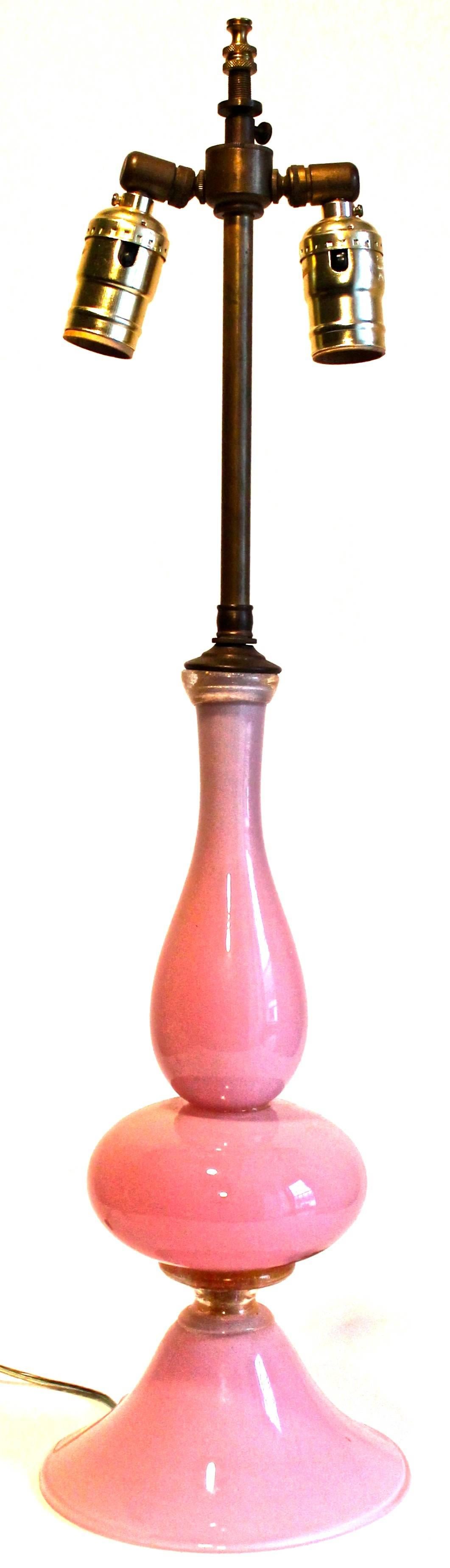 Classic form glass table lamp. Pink translucent over white, connecting details of clear glass with gold inclusions. Measures: Height to top of harp 25