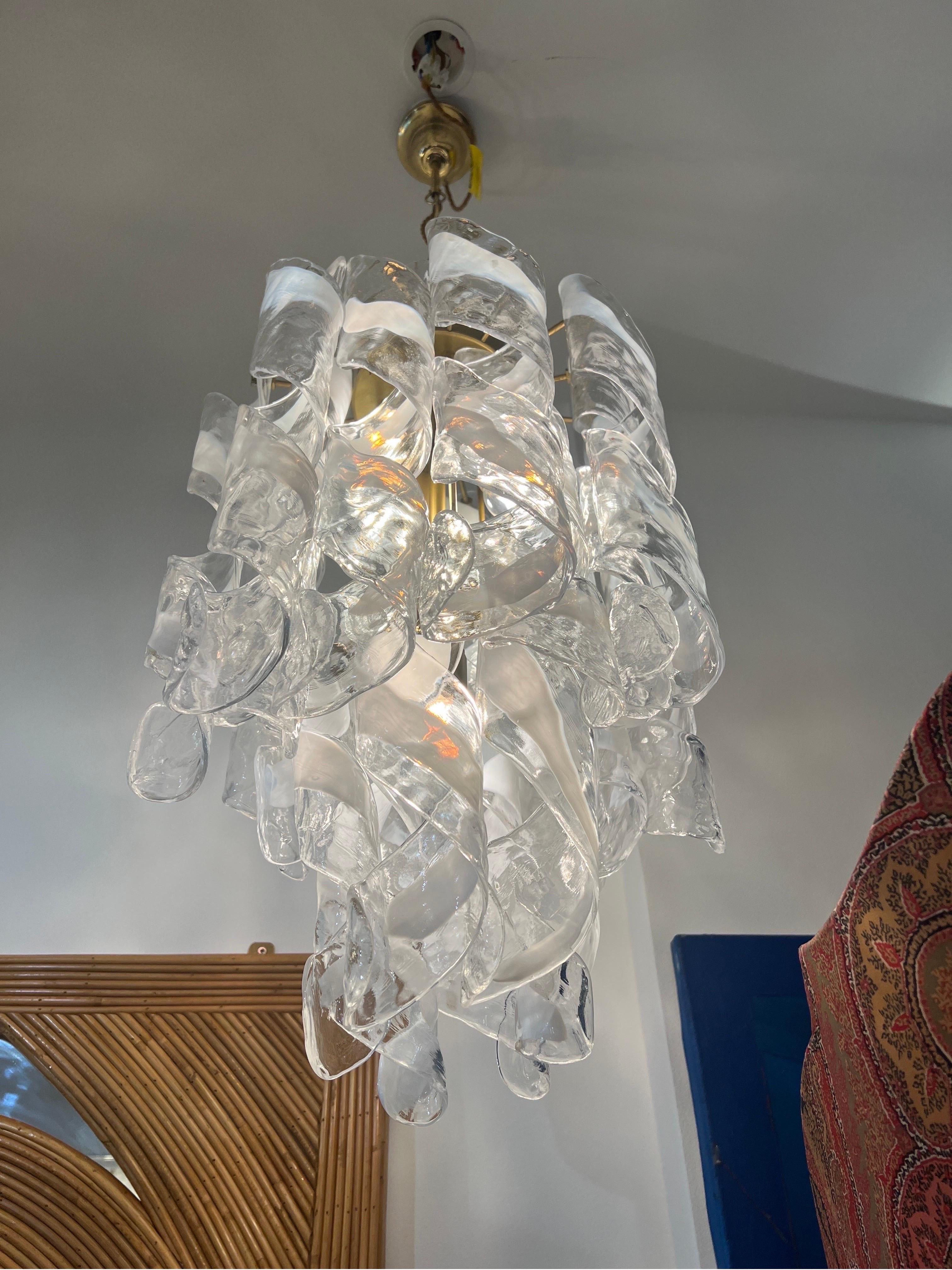 A mazzega chandelier with clear and opalin Murano glass blown into twisted spiral shapes and supported by a brass structure with 4 bulbs . 
Italy 1960s 
Measurements exclude chain and ceiling cap .