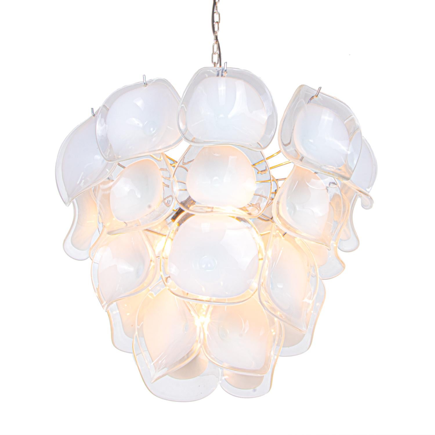 Elegant design pendant lamp chandelier with white and clear glass petal shaped hand blown Murano glass elements on a chromed frame. 

Designed by Gino Vistosi. 
Manufactured by Mazzega in the 19860s.
Measures: diameter 21.65