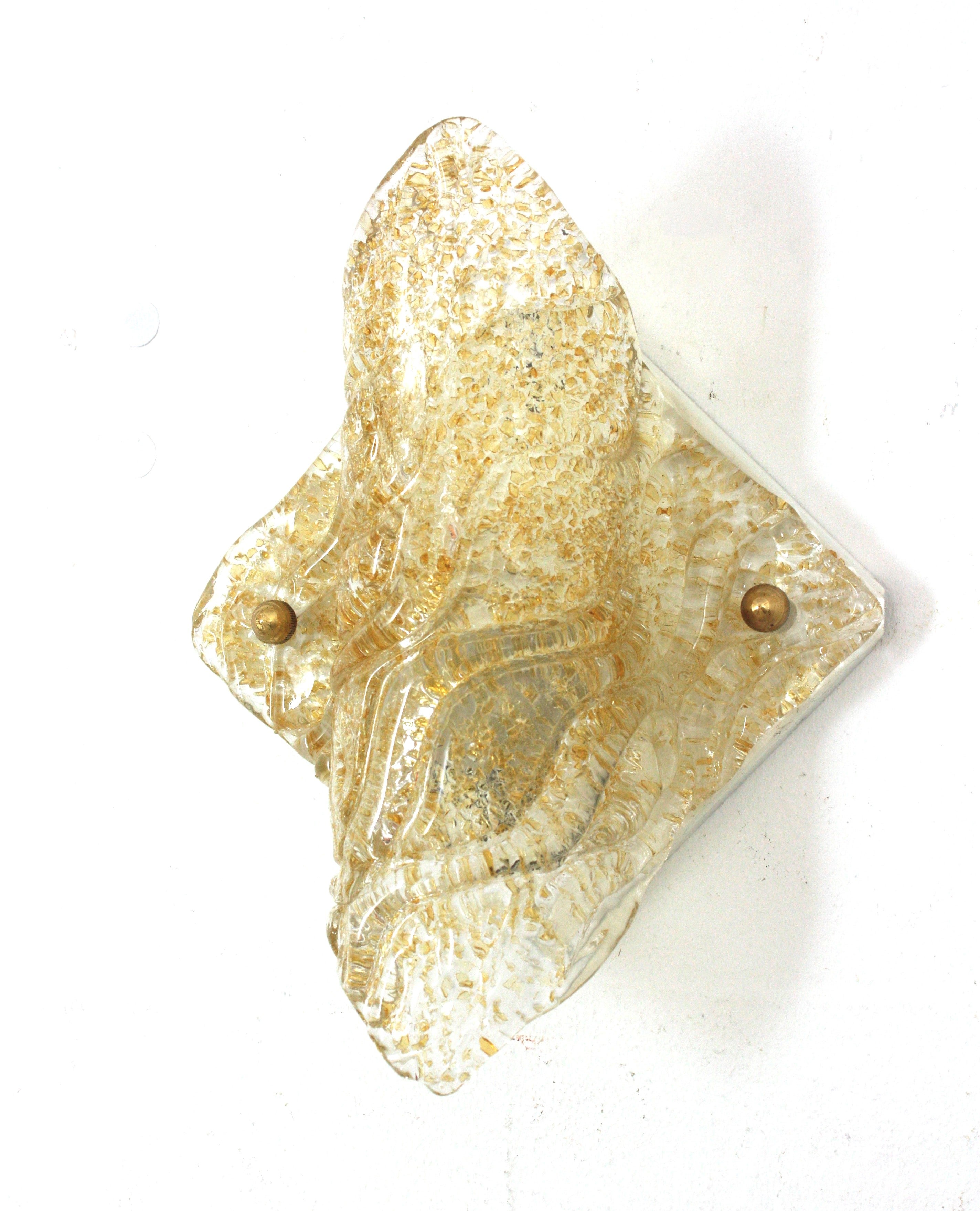 Hand Blown Murano Gold Flecks Clear Glass Wall Sconce, Italy 1960s
Attributed to Mazzega. 
This eye-catching rhombus shaped wall sconce was manufactures with the rugiadoso technique, with small particles of glass at the interior part to difusse the