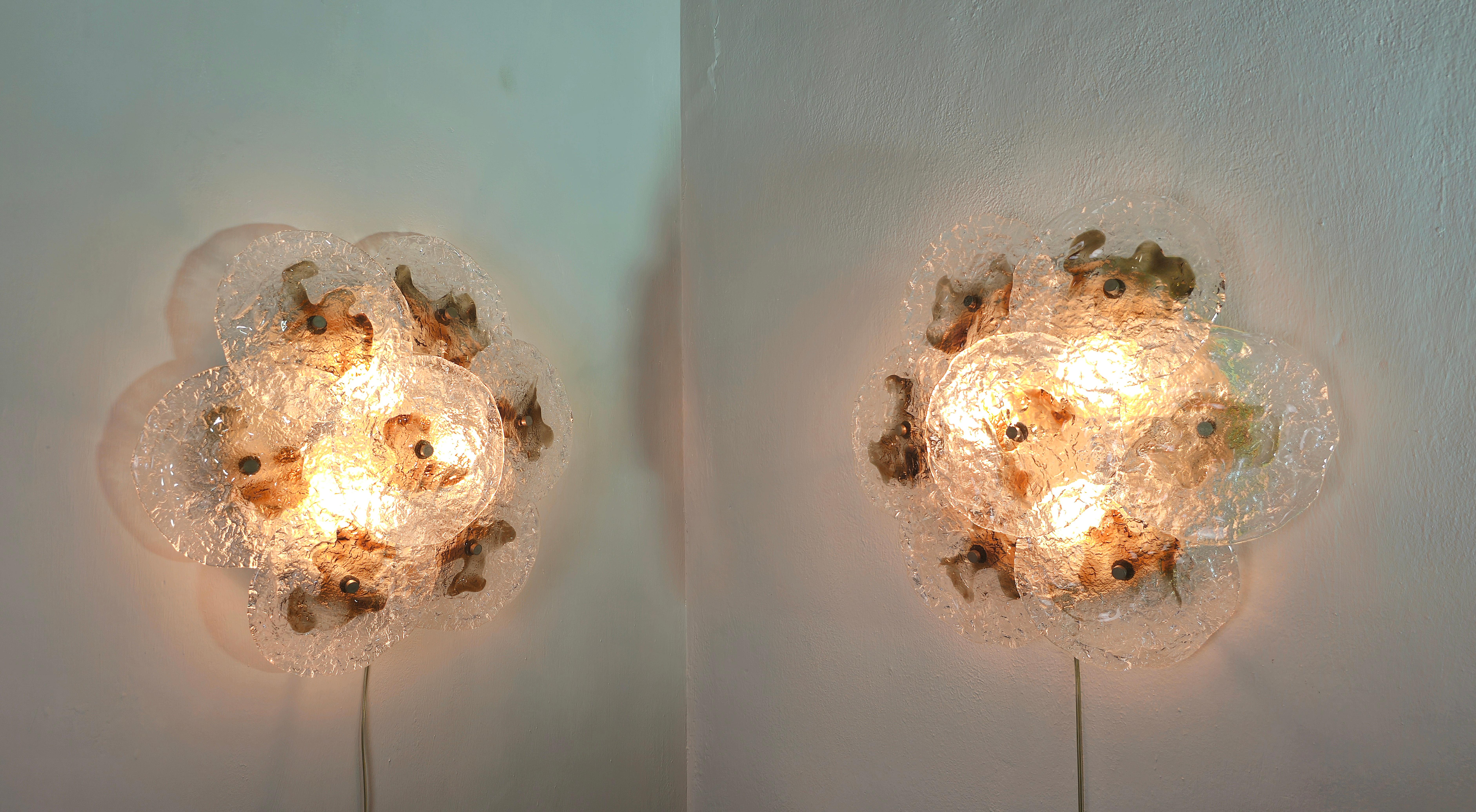 Set of 2 wall or roof lamps produced in Italy in the 70s Mazzega, They have no breaks or missing parts. Glasses intact. Only slight signs of wear over time.
Each single wall lamp was made with 7 two-tone glasses which are supported by a metal and
