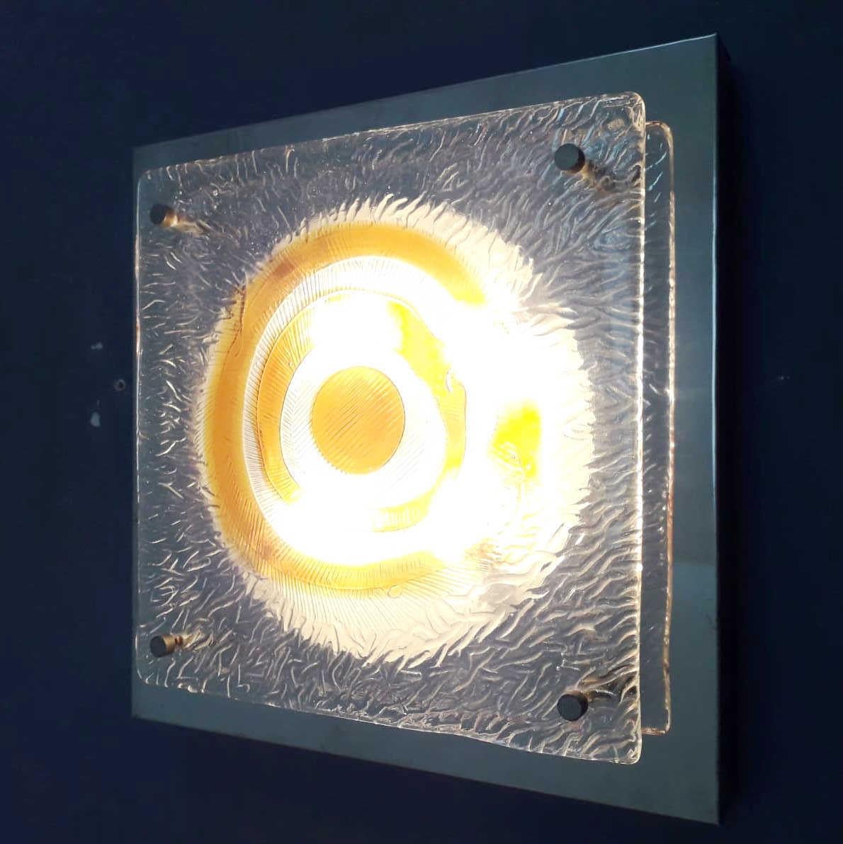 Italian vintage wall light or flushmount with a clear and amber Murano glass diffuser mounted on chrome frame / Made in Italy circa 1960s
4 lights / E12 or E14 type / max 40W each
Measures: length 14 inches, width 14 inches, height 3 inches
1