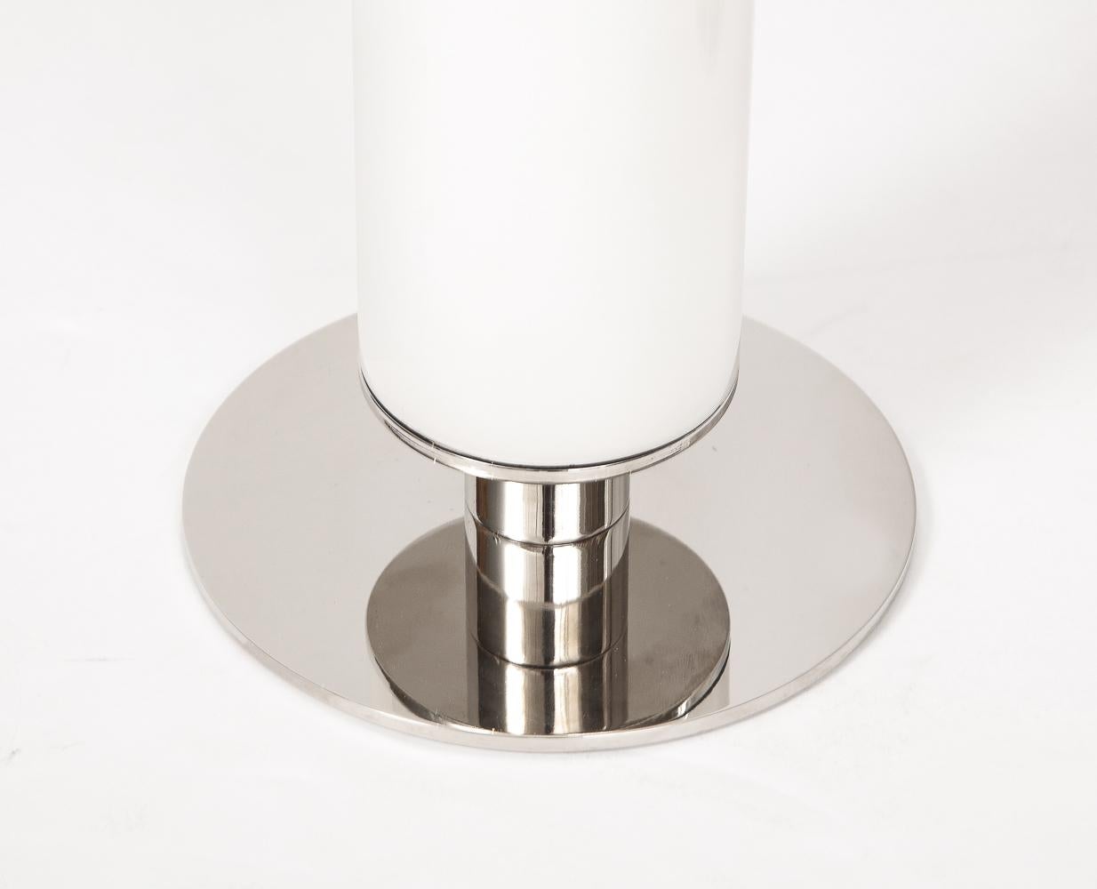 White & silver colored glass and chrome bases. Fabric lamp shades. Each lamp takes 2 candelabra bulbs.