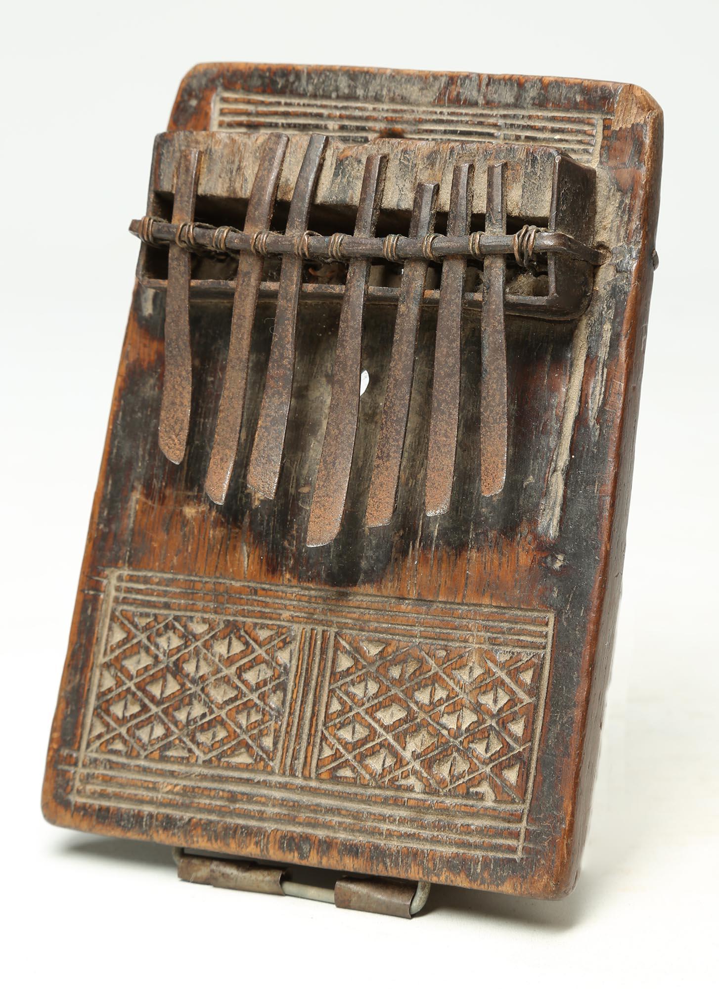Mbira or Sanza (once known as a thumb piano), wood with metal keys, with finely incised geometric design. Created in the early 20th century, Congo, Central Africa, possibly by an artist/ musician of the Kuba or Lele people. Wonderful age and patina