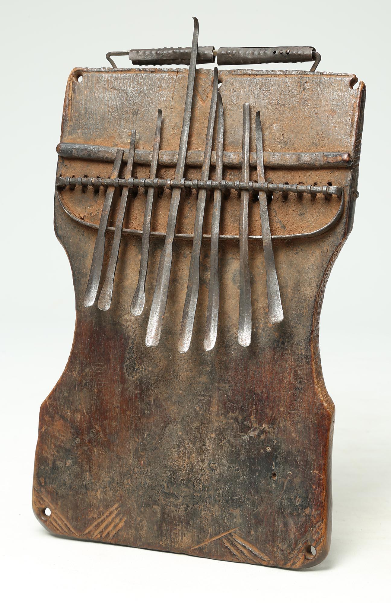 Simple, elegant Mbira or Sanza (once known as a thumb piano) of wood with metal from the Congo, Central Africa, late 19th to early 20th century. With wonderful age and patina from handling, matching wear to the original metal keys. 8 1/2 x 5 1/8 x 1