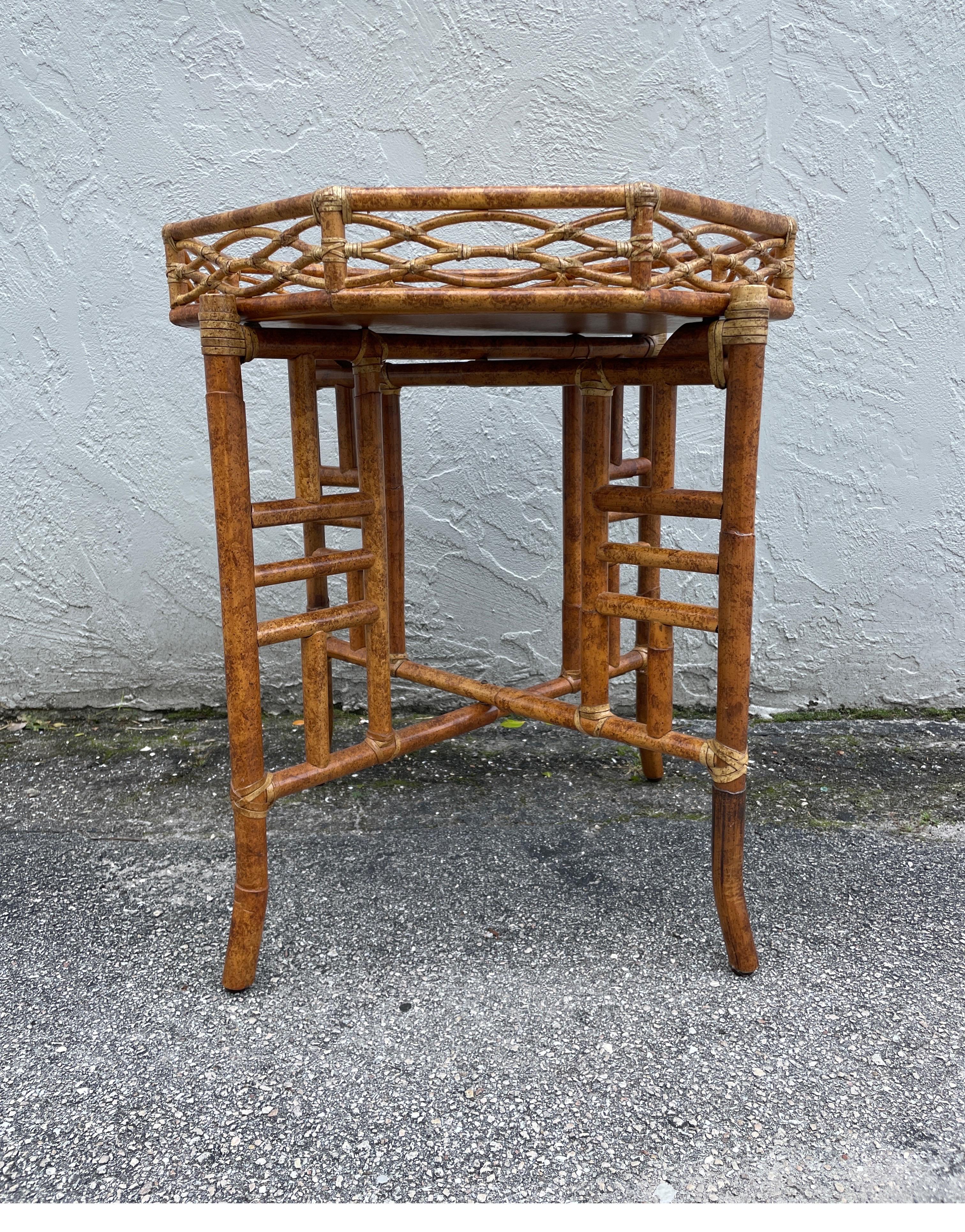 Vintage burnt bamboo & cane Chinoiserie style octagon shaped tray table by Mc Guire. The top detaches for serving purposes. Base also folds flat for storage. A great addition to any room. A true classic.