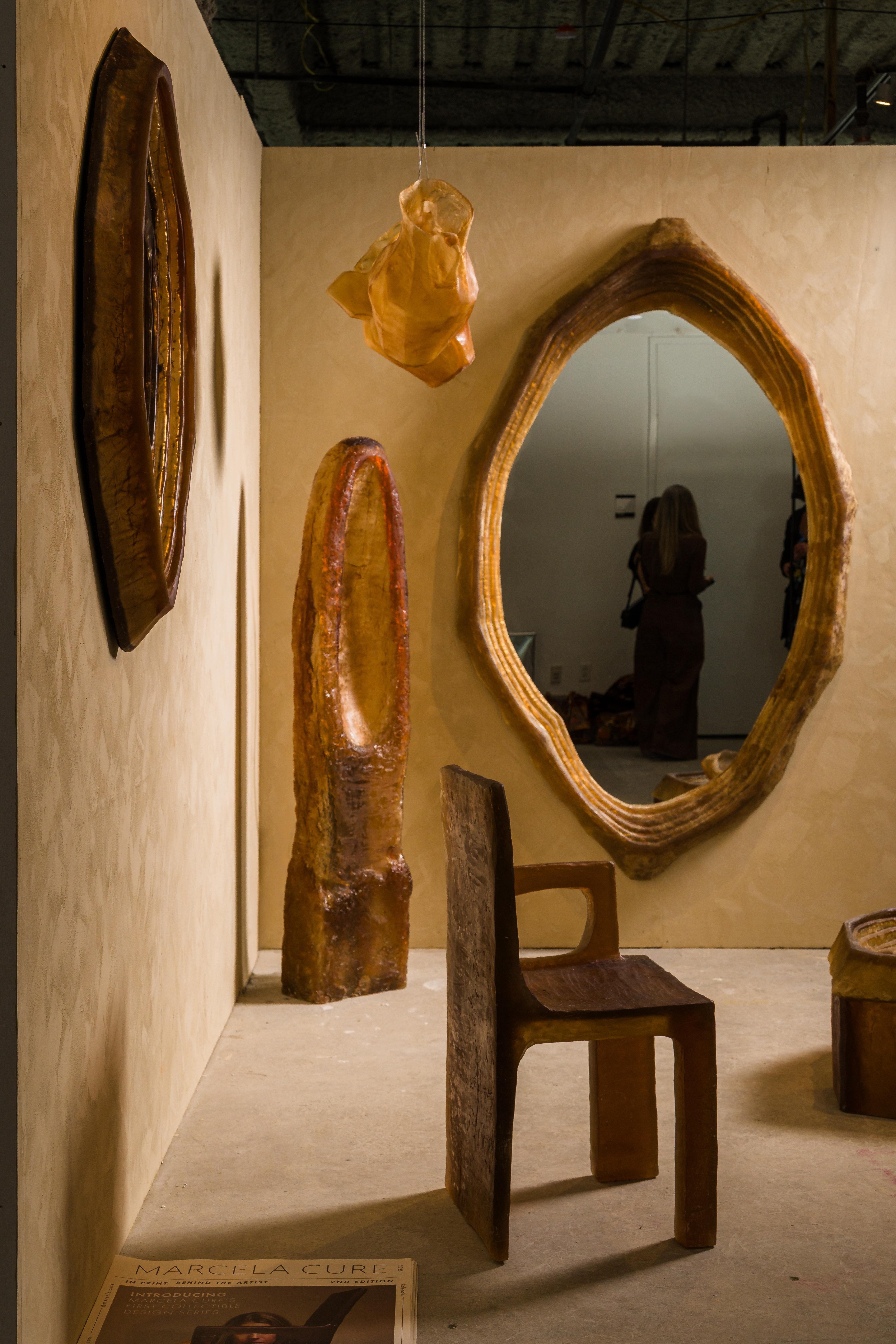 A monumental mirror carved with topographic contours. Its organic asymmetry and glowing depth evoke ancient landscapes and inner reflection. A statement wall piece that anchors the collection.

Materia Colectiva is a sculptural reflection on