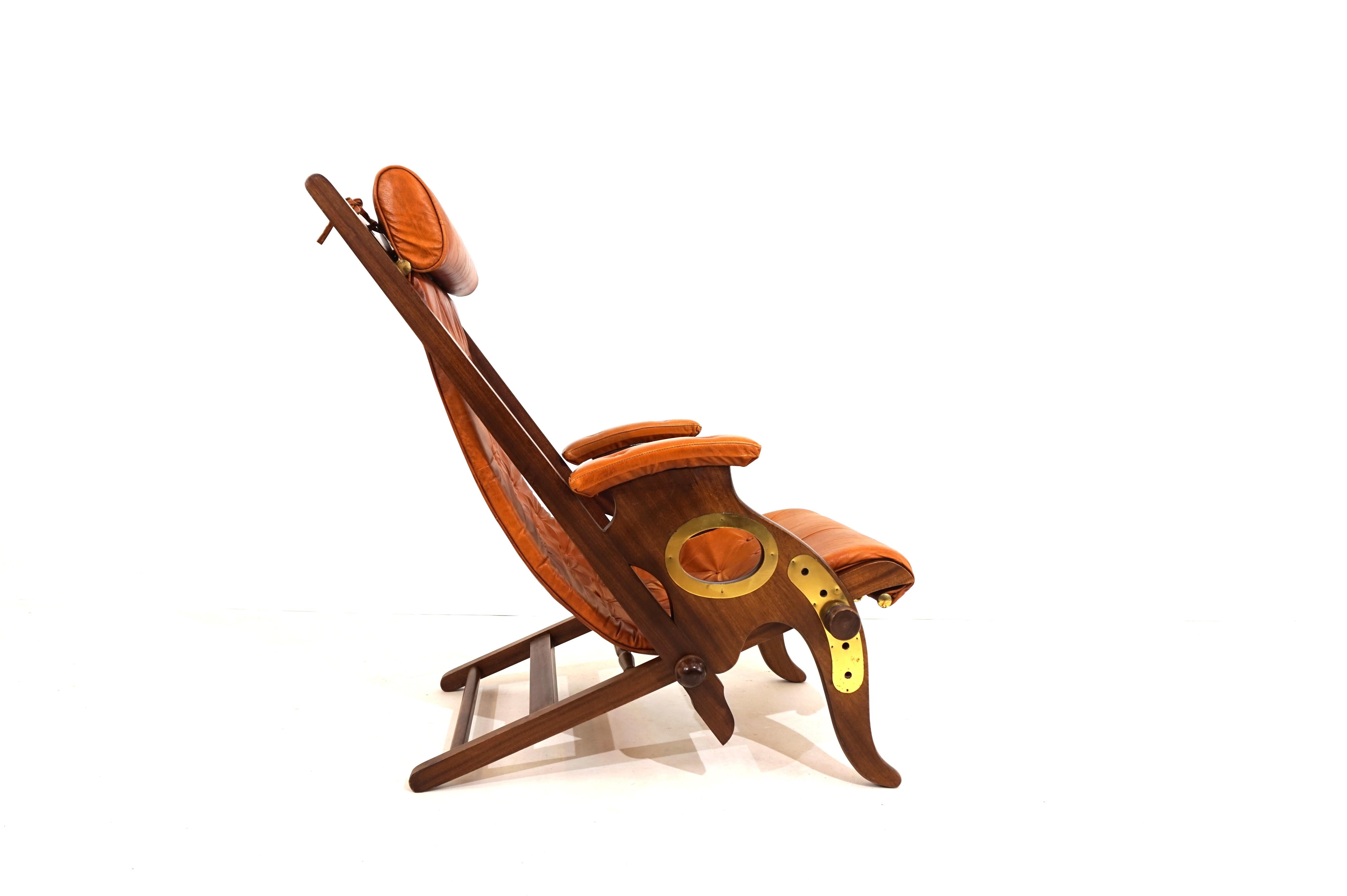 Exceptional McNair Military Campaign Chair with a solid oak frame from the early 20th century. The wooden frame is in very good condition, the wood is stained dark and the openings are framed with brass frames. The cognac-colored leather in
